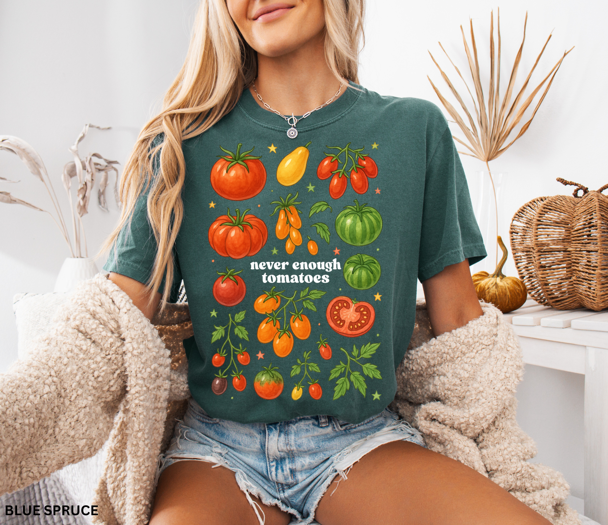 Watercolor-style illustration of different tomato varieties with the phrase “never enough tomatoes” on a cottagecore garden t-shirt.