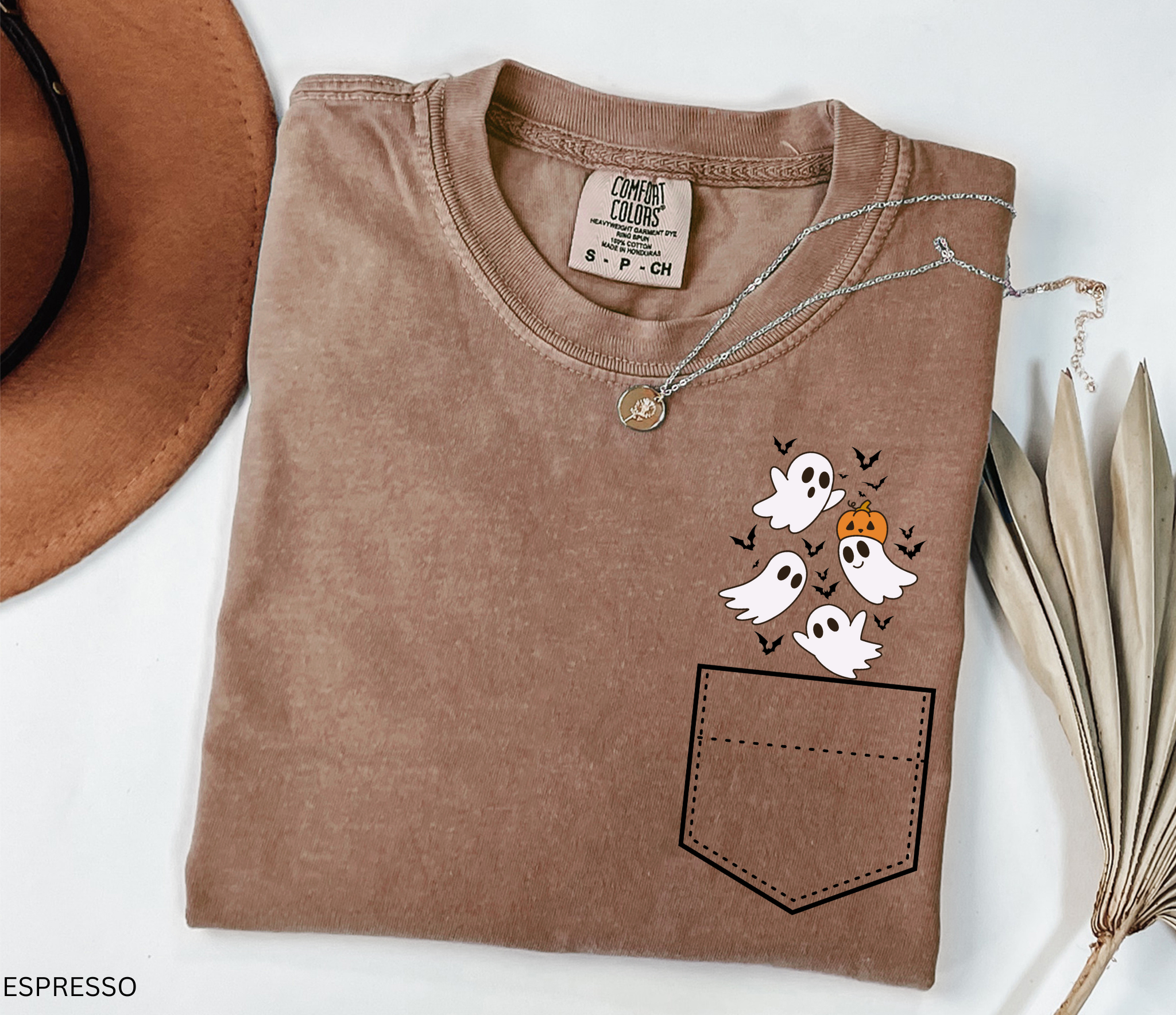 Halloween pocket shirt design with a group of smiling ghosts, a pumpkin, and bats peeking from the top corner.