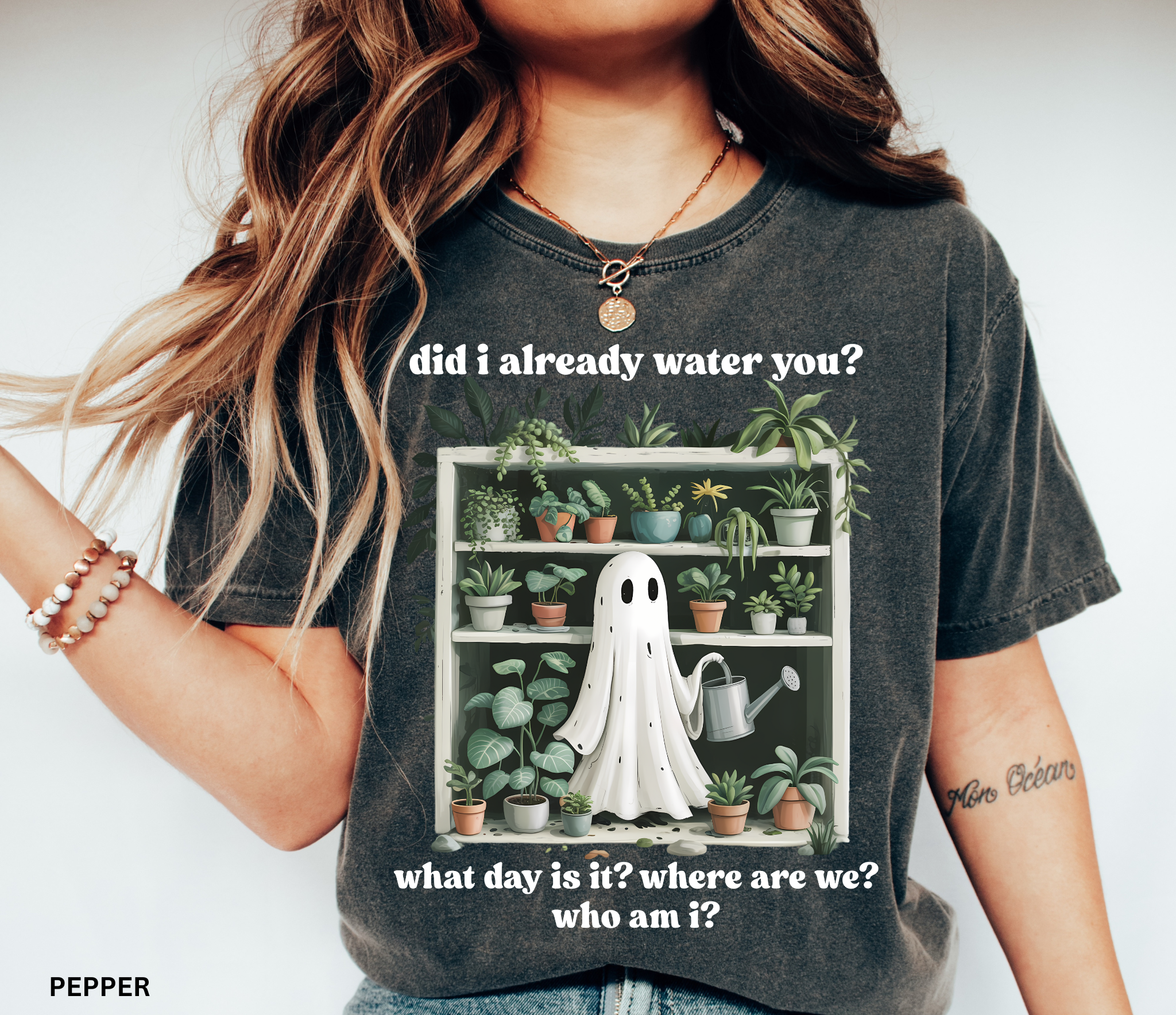 Funny gardening shirt featuring a ghost holding a watering can in front of a shelf full of houseplants with the phrase “Did I already water you? What day is it? Where are we? Who am I?”