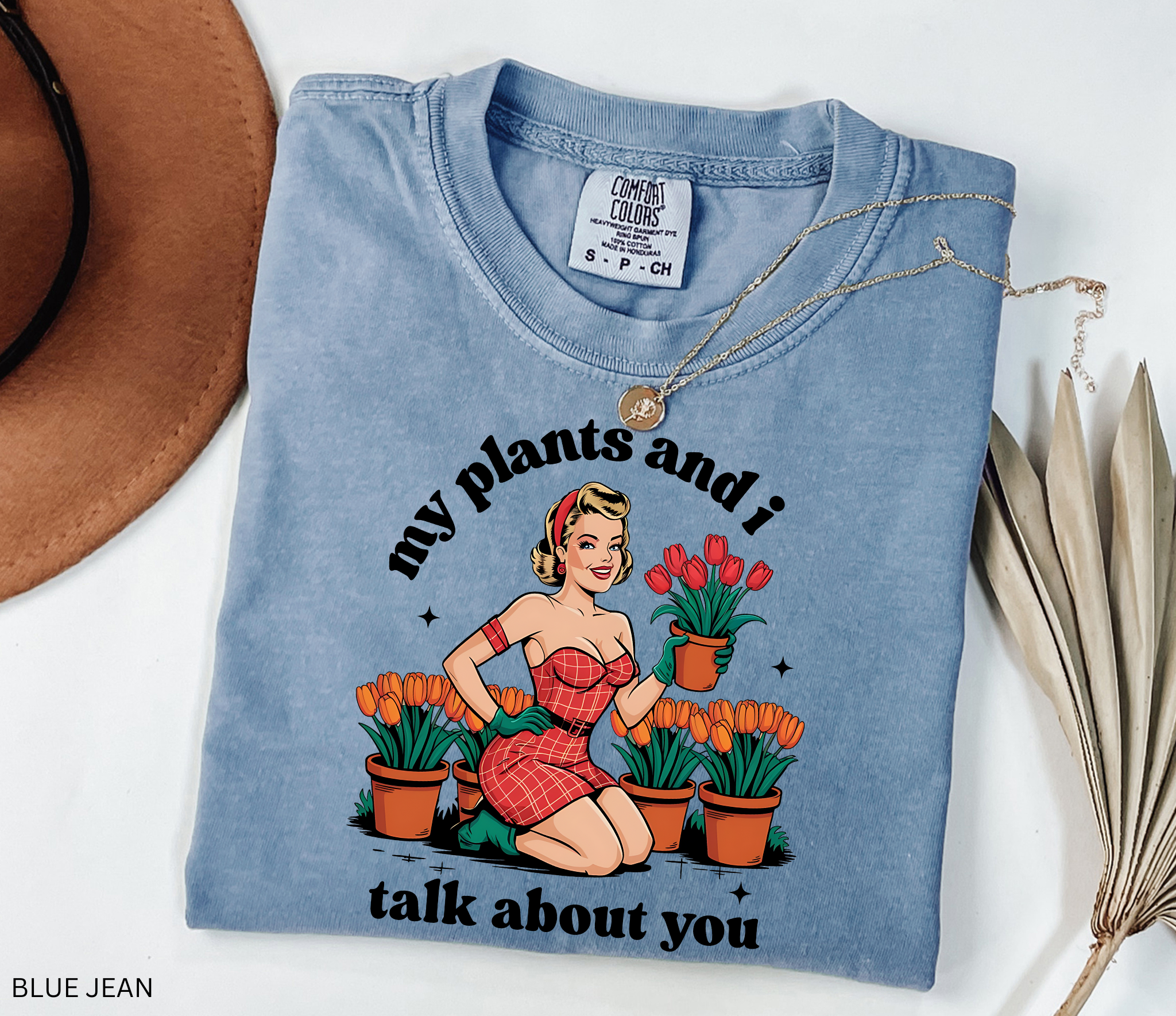 Vintage pin-up style illustration of a glamorous woman in a red dress holding a pot of tulips, surrounded by rows of tulip plants.