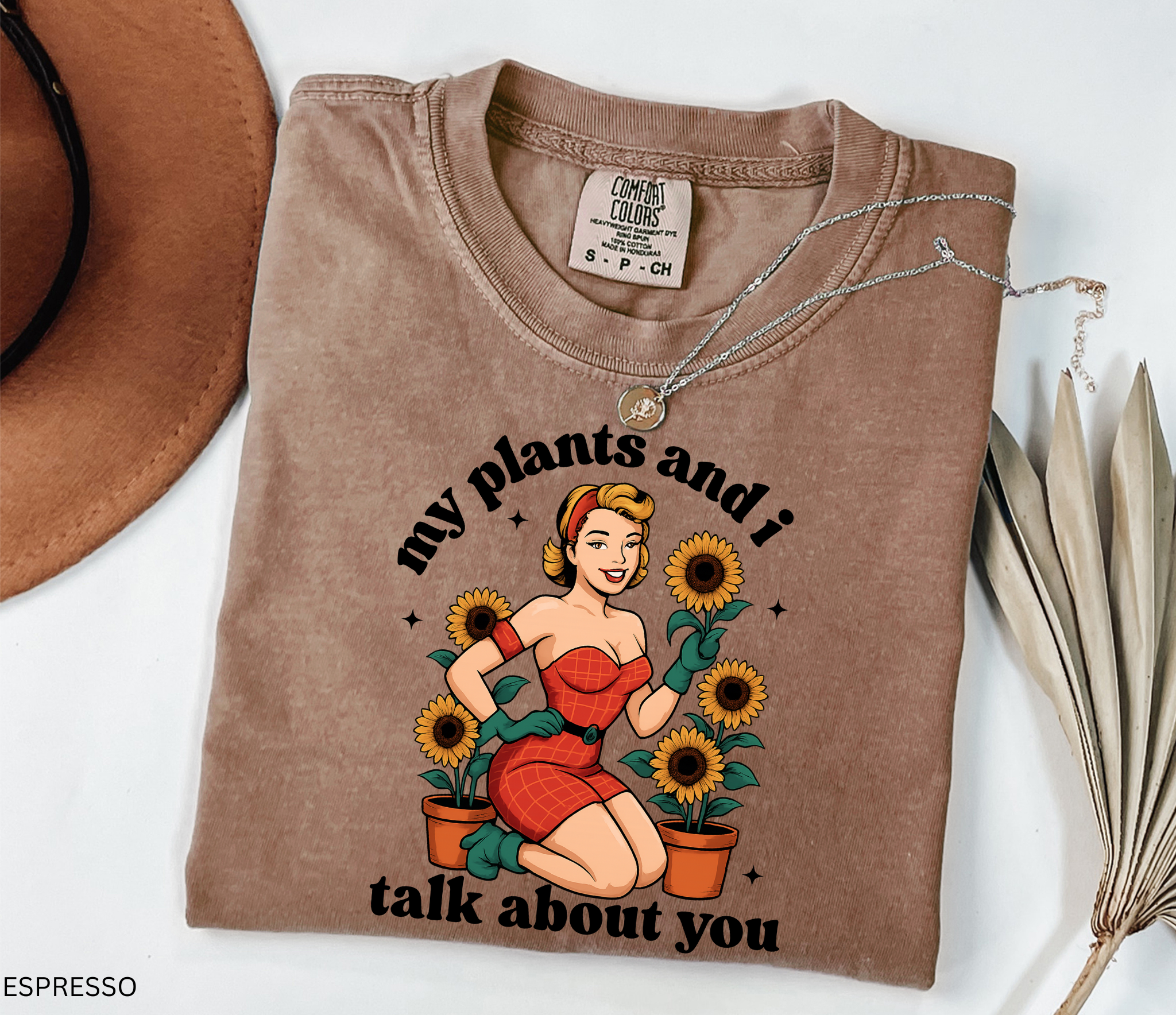 Vintage pin-up style illustration of a glamorous woman in a red dress surrounded by potted sunflowers, printed on a retro gardening t-shirt.