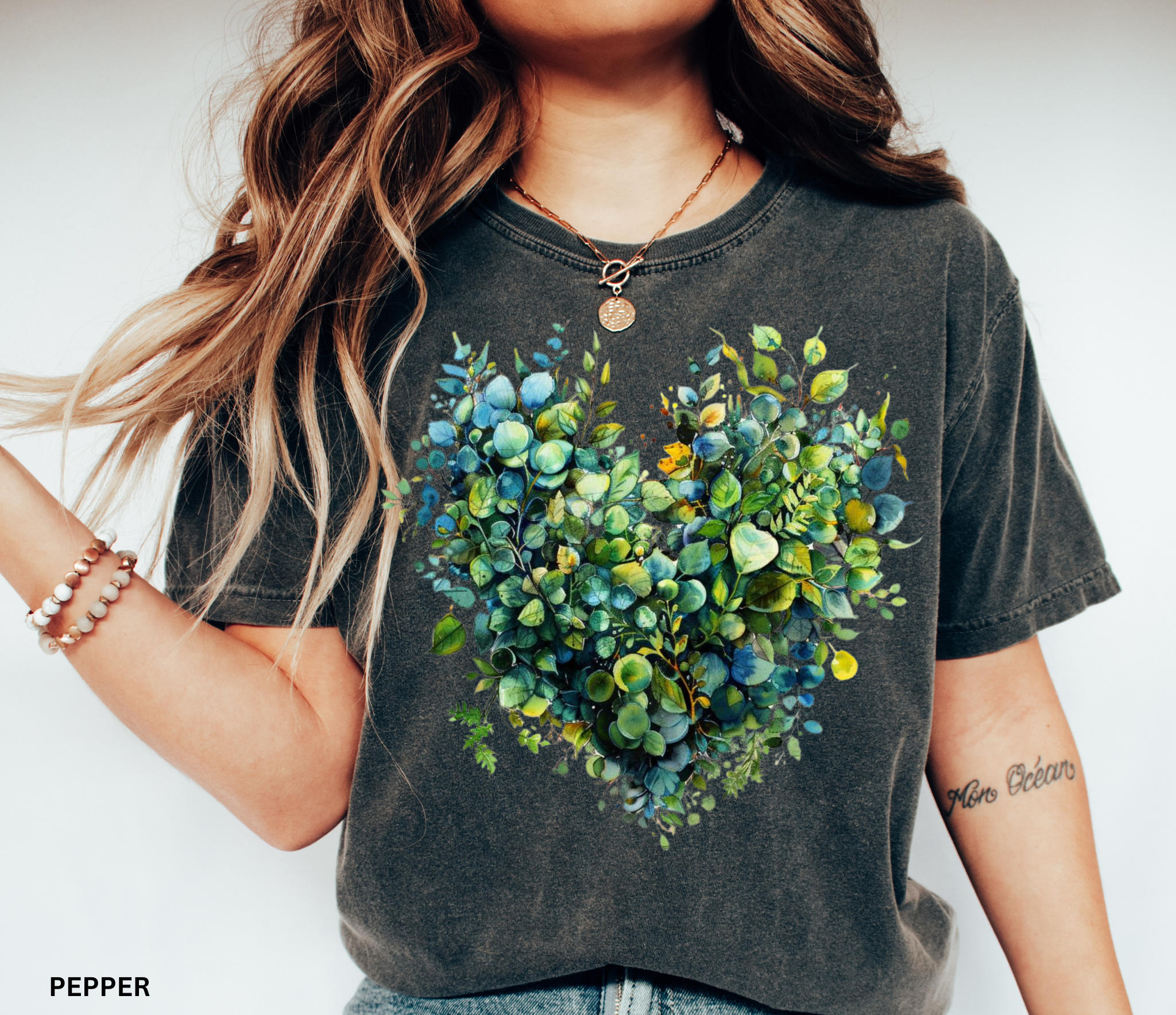 Watercolor-style greenery arranged in the shape of a heart, printed as a botanical design on a cottagecore t-shirt.