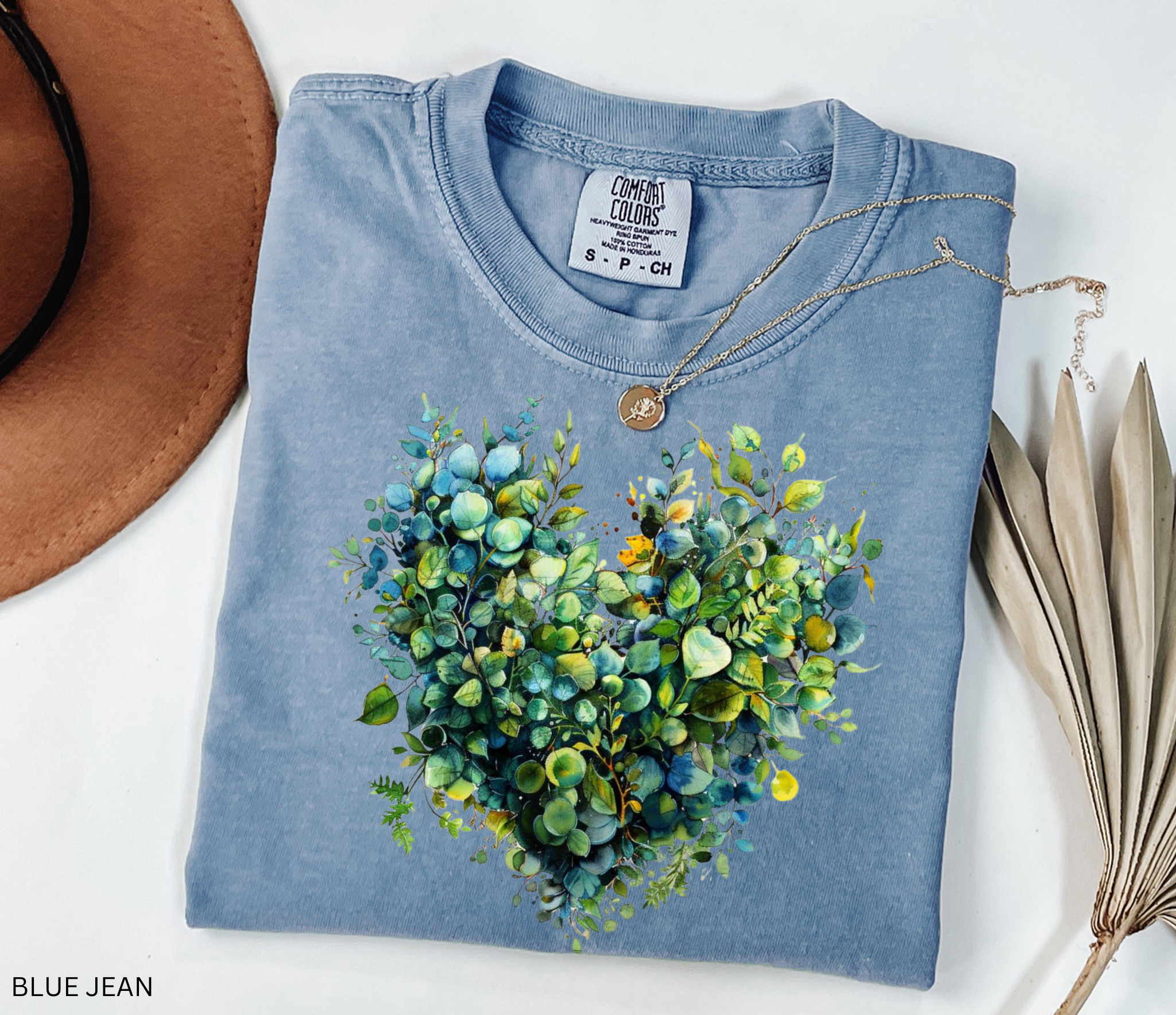 Watercolor-style greenery arranged in the shape of a heart, printed as a botanical design on a cottagecore t-shirt.