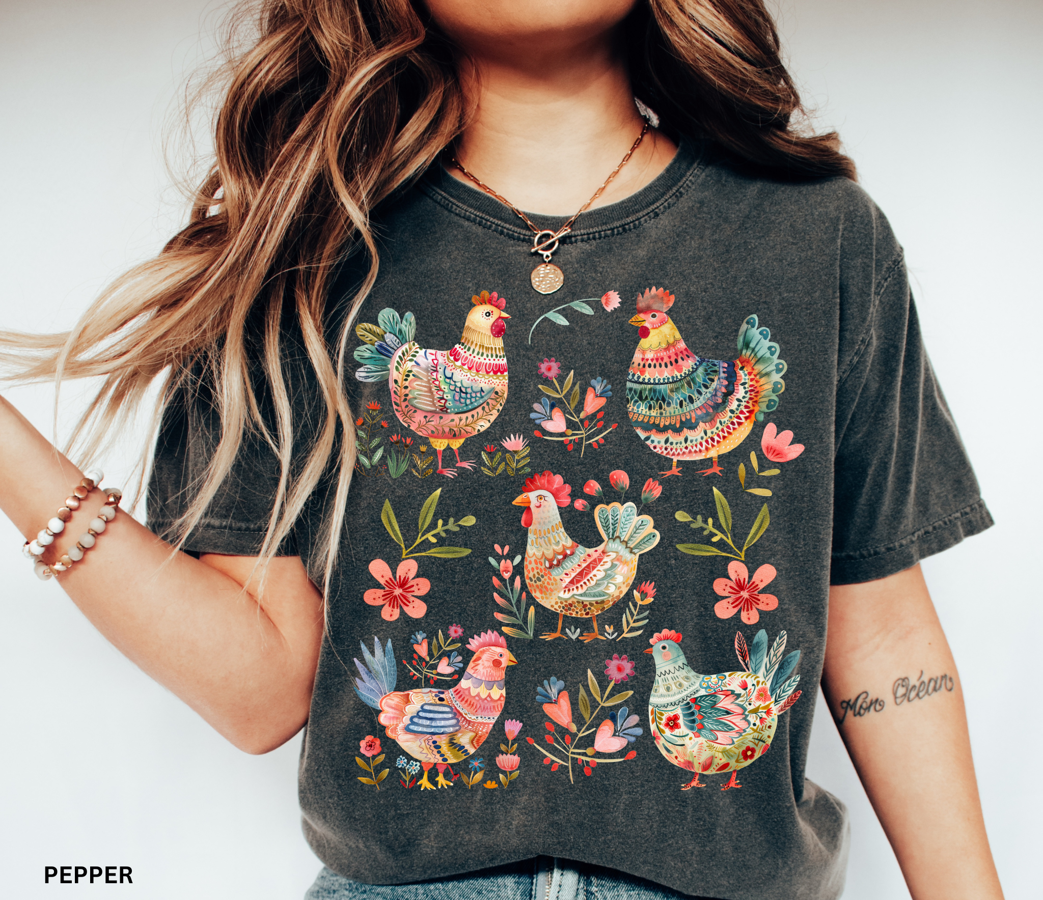 Whimsical folk art style chickens surrounded by colorful flowers, printed as a cottagecore farmhouse design on a t-shirt.