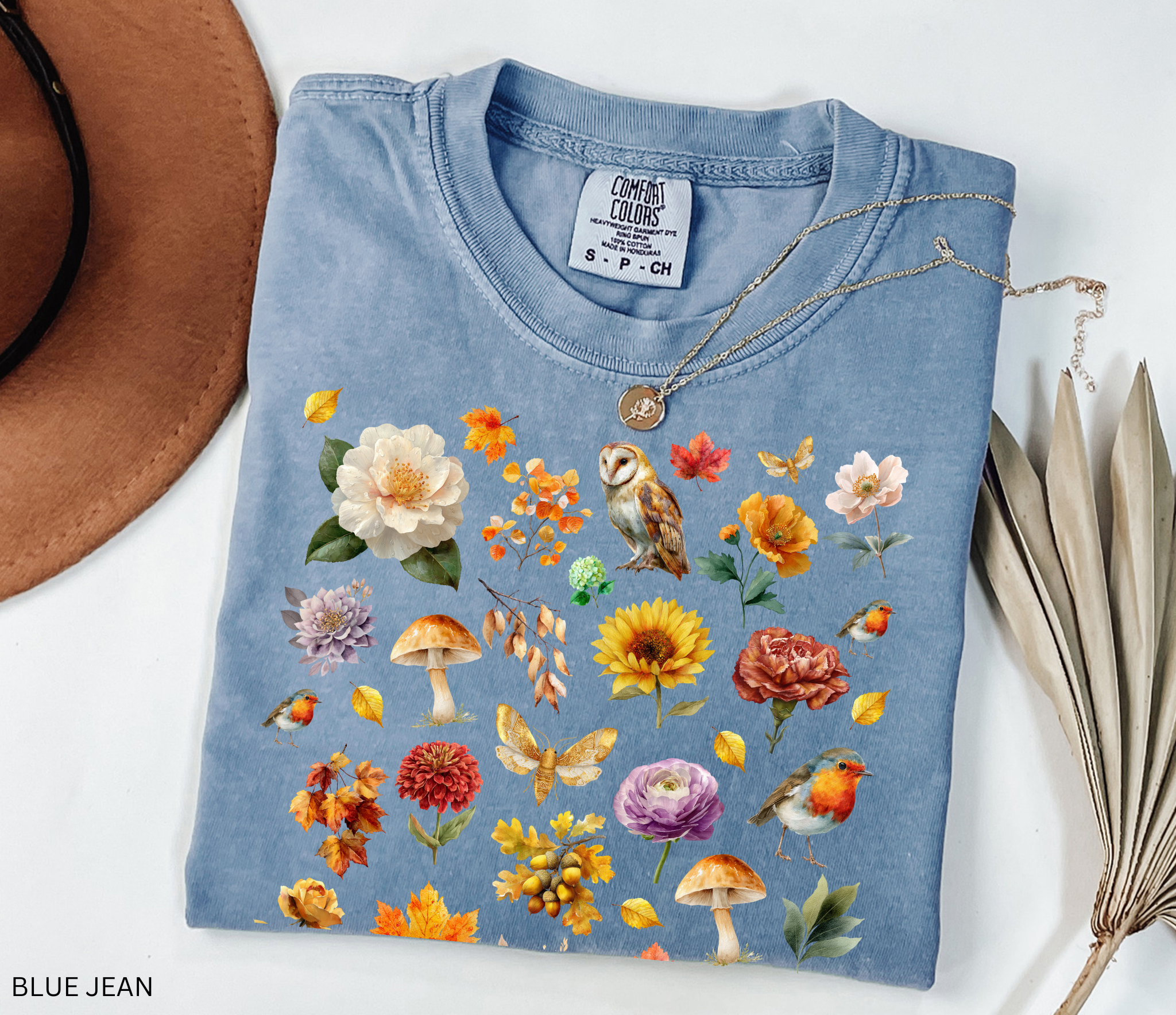 Watercolor woodland collage design featuring owls, robins, mushrooms, butterflies, fall leaves, and florals on an autumn cottagecore shirt.