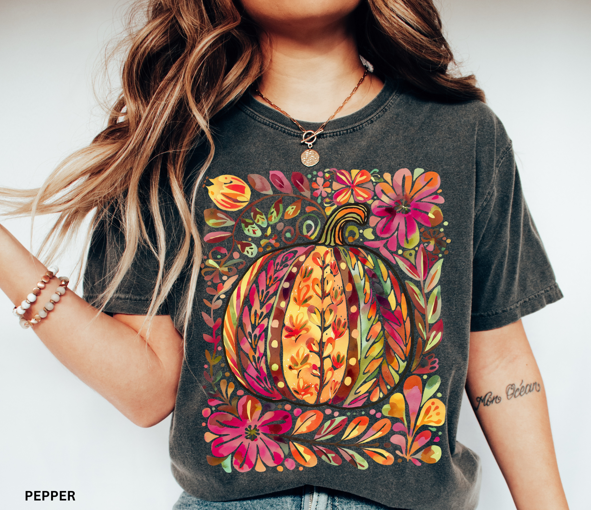 Watercolor collage of autumn leaves, butterflies, flowers, and birds in warm tones — cottagecore nature-inspired design on a cozy unisex shirt.