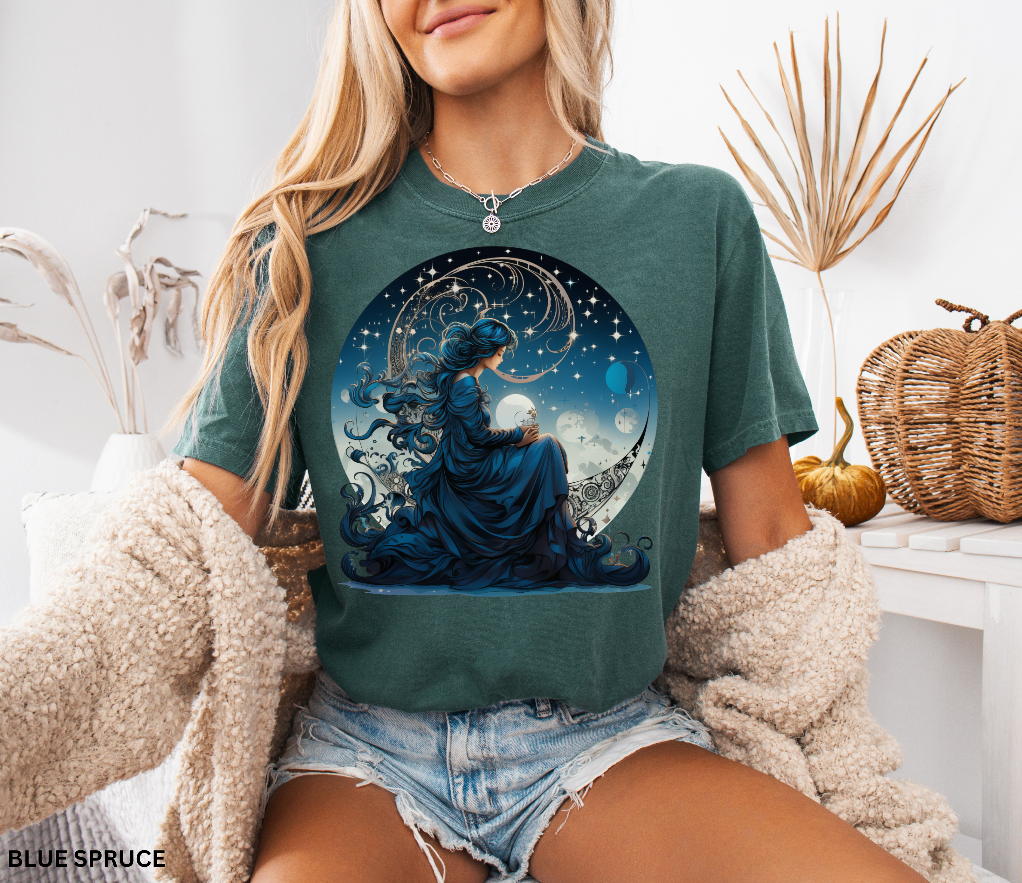 Celestial witch sitting on crescent moon surrounded by stars, blue cosmic aesthetic t-shirt design