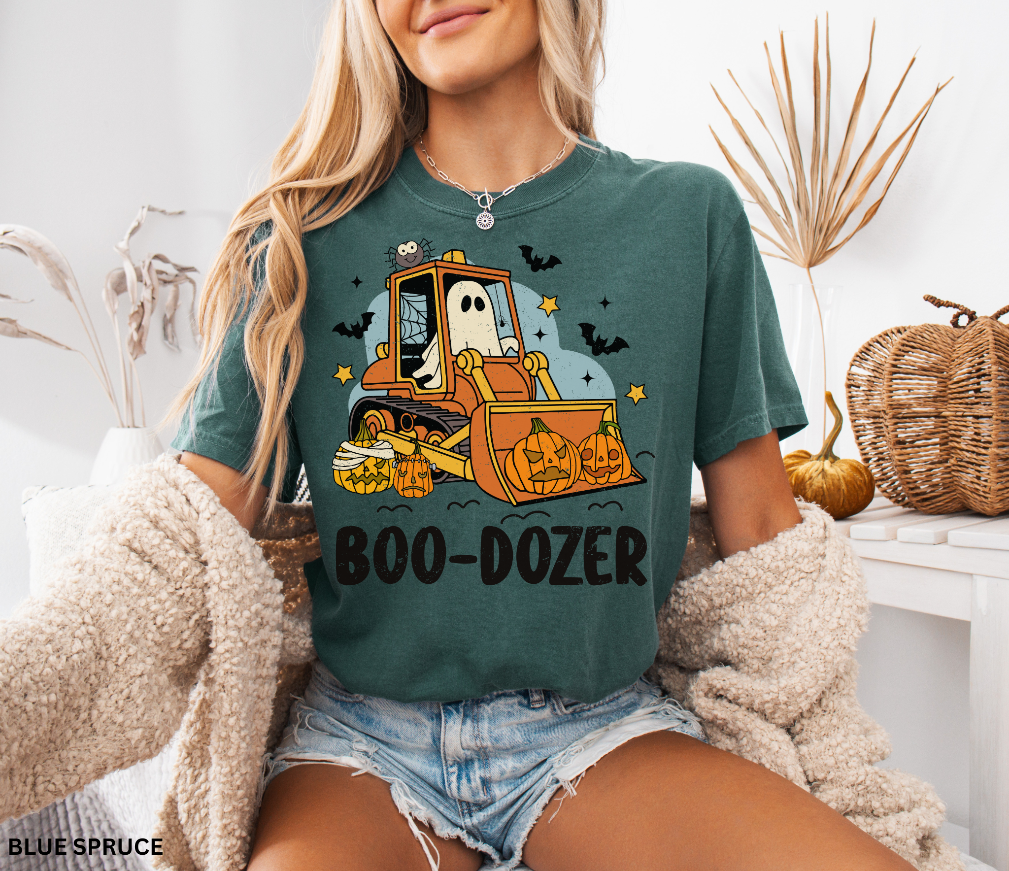 Cute Halloween ghost driving a bulldozer with pumpkins — funny Boo-Dozer shirt design