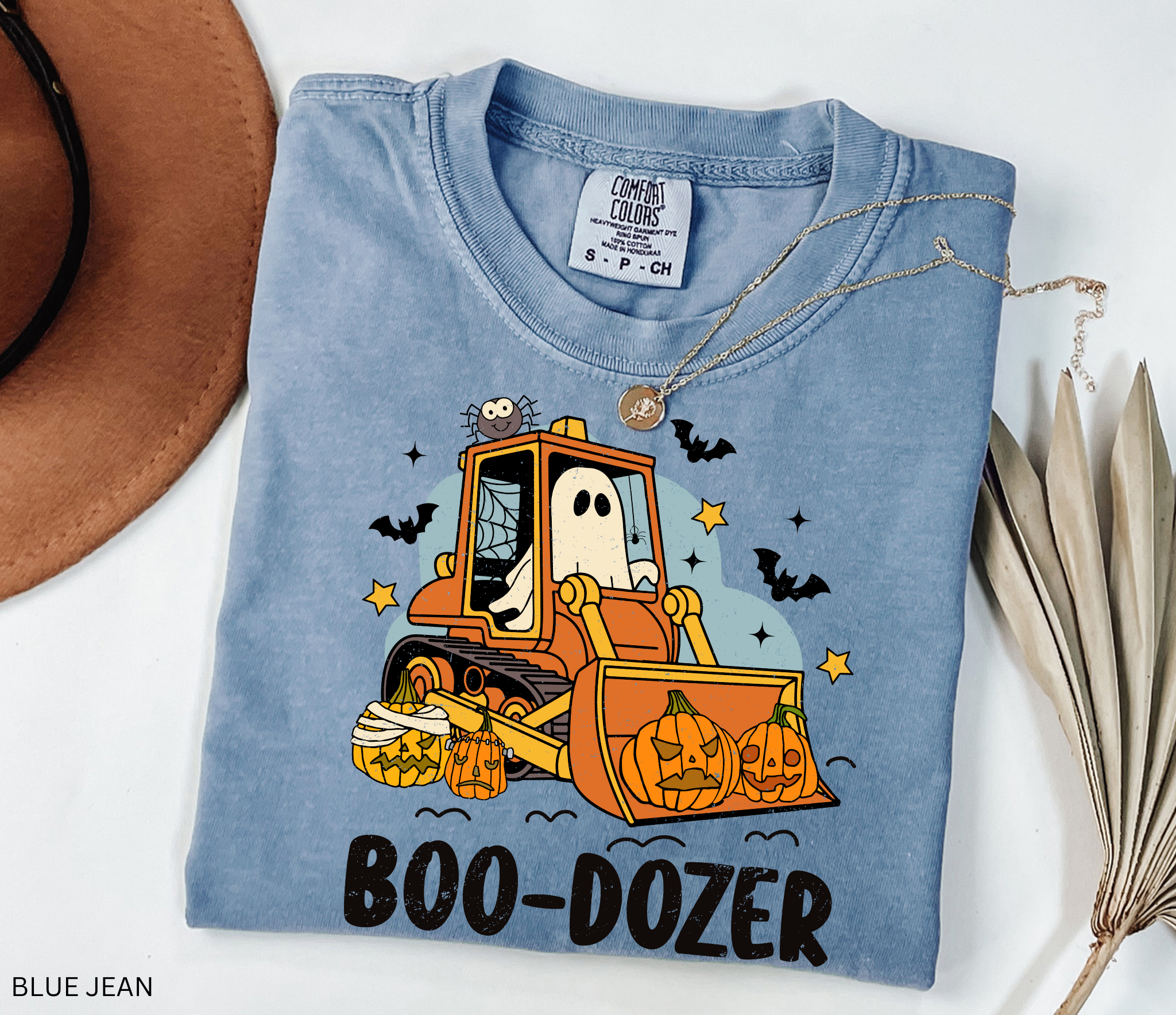 Cute Halloween ghost driving a bulldozer with pumpkins — funny Boo-Dozer shirt design
