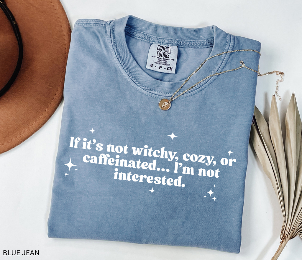 Funny witchy coffee lover shirt reading “If it’s not witchy, cozy, or caffeinated, I’m not interested” — witch aesthetic tee on Comfort Colors fabric.