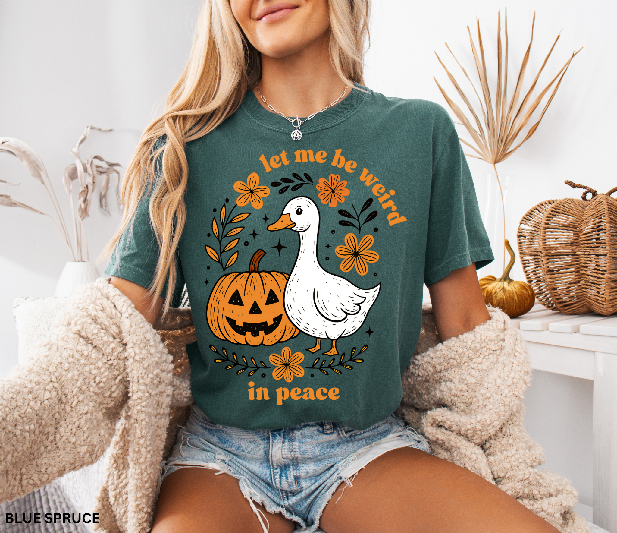 Funny Halloween goose t-shirt featuring “Let Me Be Weird in Peace” text, pumpkin, and flowers — cottagecore fall aesthetic design on Comfort Colors shirt.