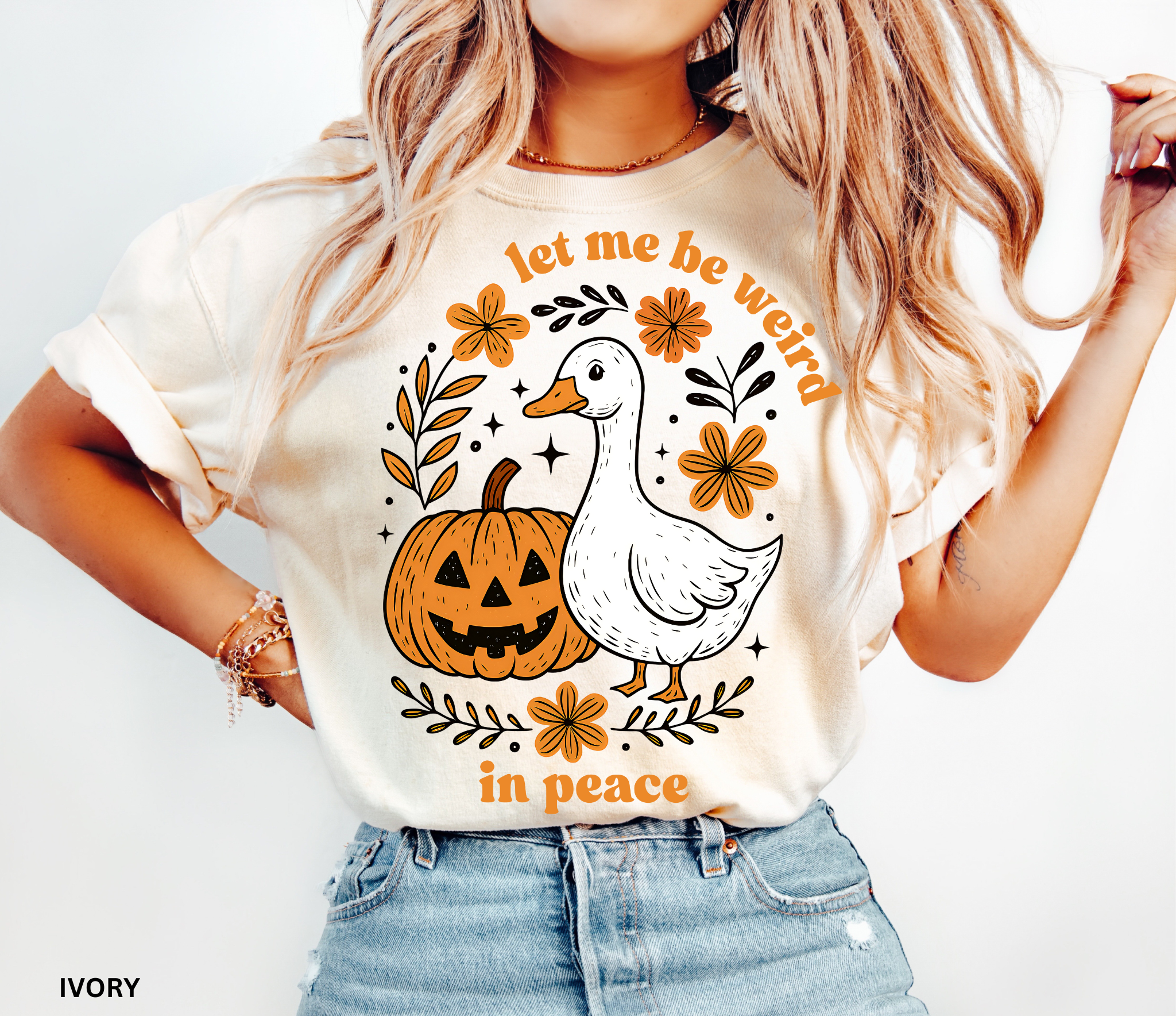 Funny Halloween goose t-shirt featuring “Let Me Be Weird in Peace” text, pumpkin, and flowers — cottagecore fall aesthetic design on Comfort Colors shirt.