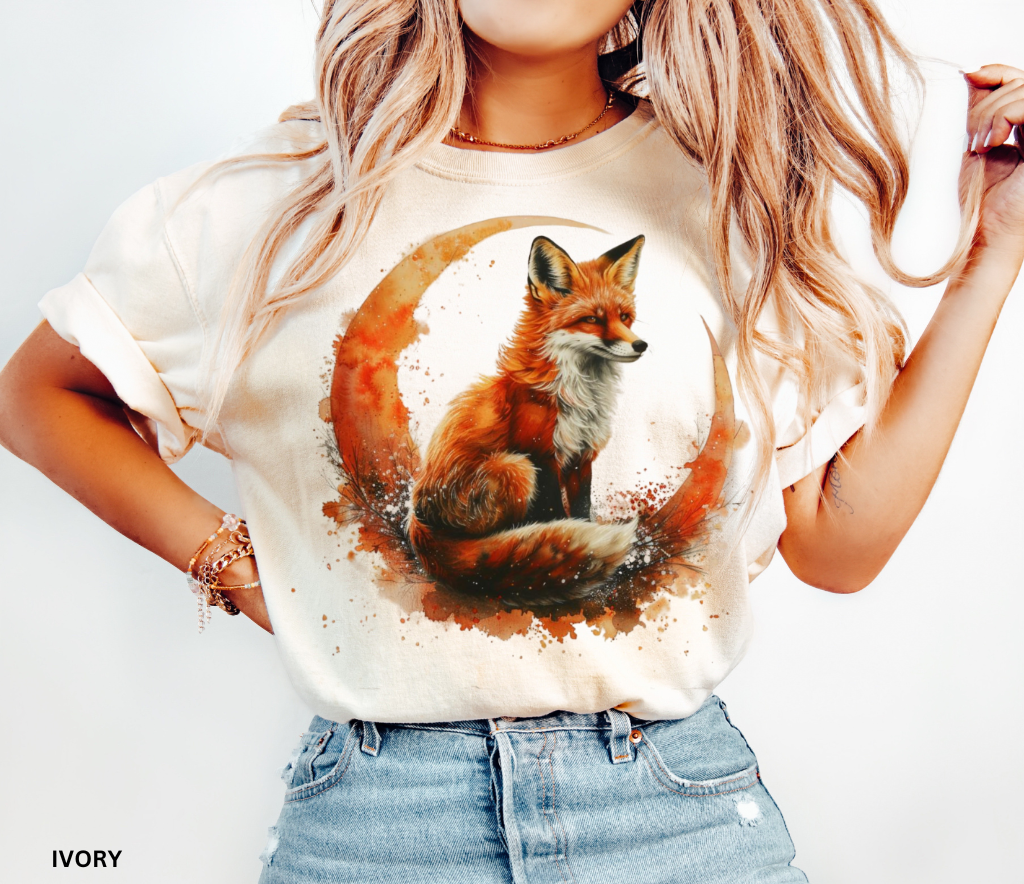 Watercolor fox sitting on crescent moon — whimsigoth forestcore design printed on Comfort Colors shirt for cottagecore aesthetic lovers.