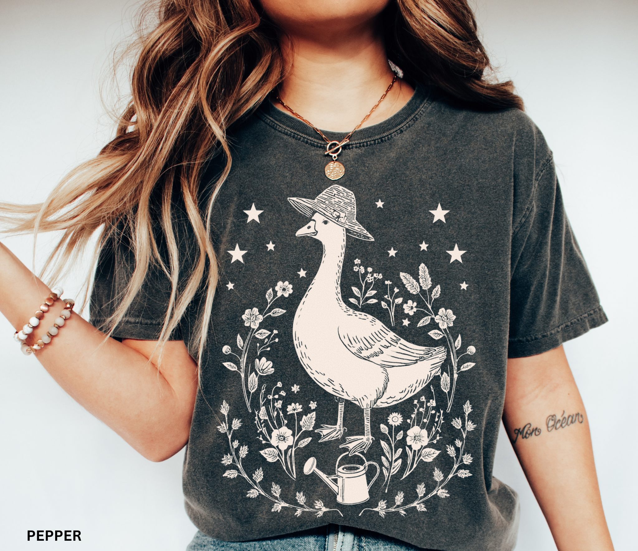 Cottagecore goose wearing hat surrounded by flowers and stars — vintage garden design printed on soft Comfort Colors shirt.