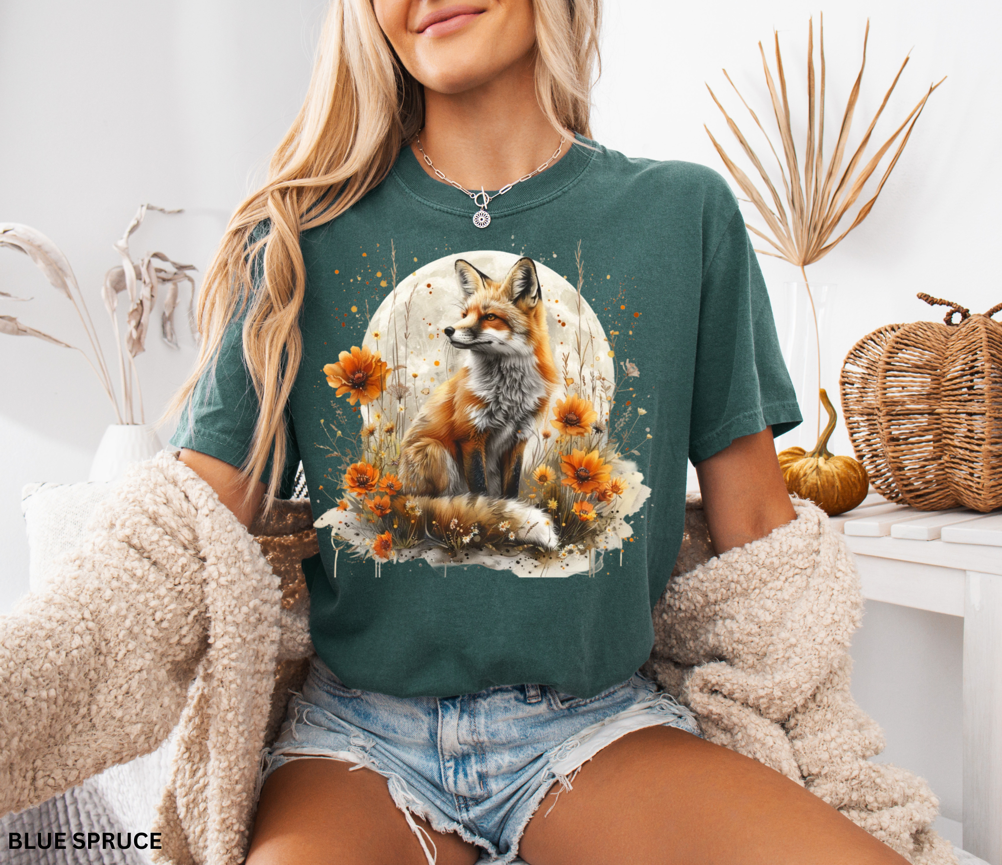 A majestic orange fox surrounded by golden wildflowers beneath a full moon on a soft Comfort Colors shirt.