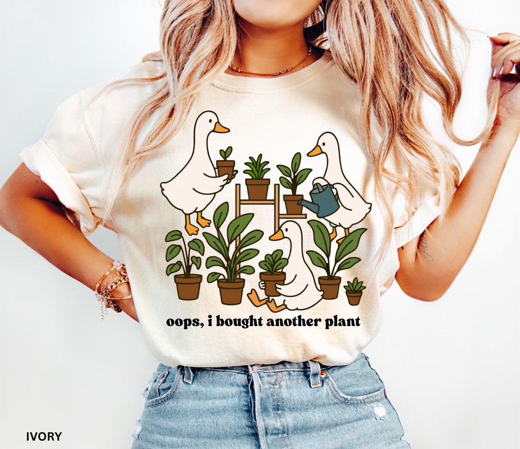 Cute shirt design featuring three geese with potted plants and the quote “Oops, I bought another plant.” Perfect for plant lovers and cottagecore style fans.
