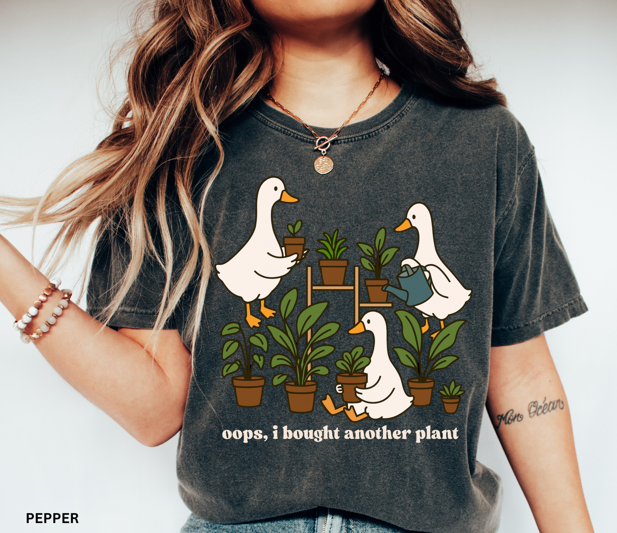 Cute shirt design featuring three geese with potted plants and the quote “Oops, I bought another plant.” Perfect for plant lovers and cottagecore style fans.