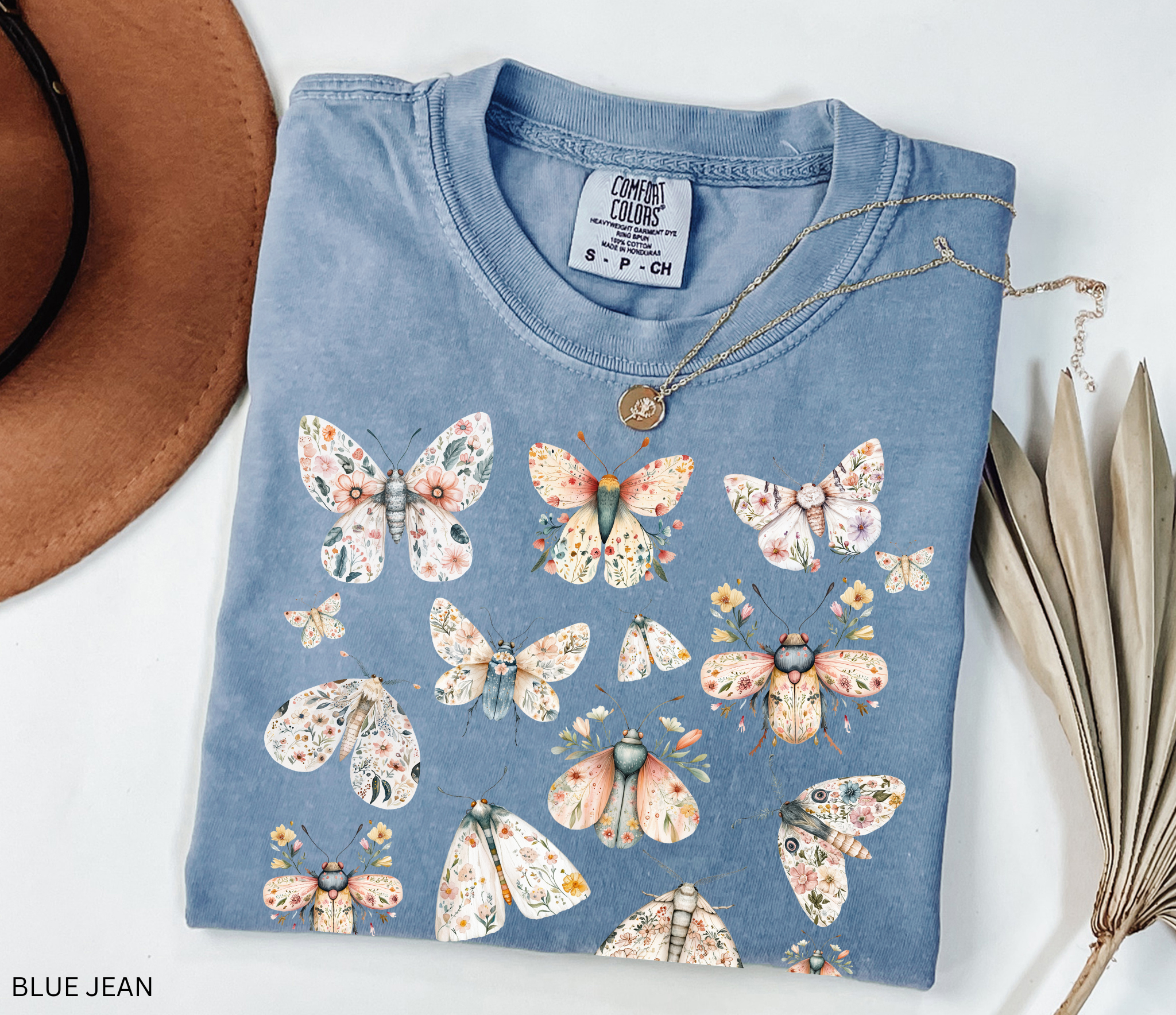 Cottagecore floral moth and butterfly shirt design with pastel flowers on delicate wings.