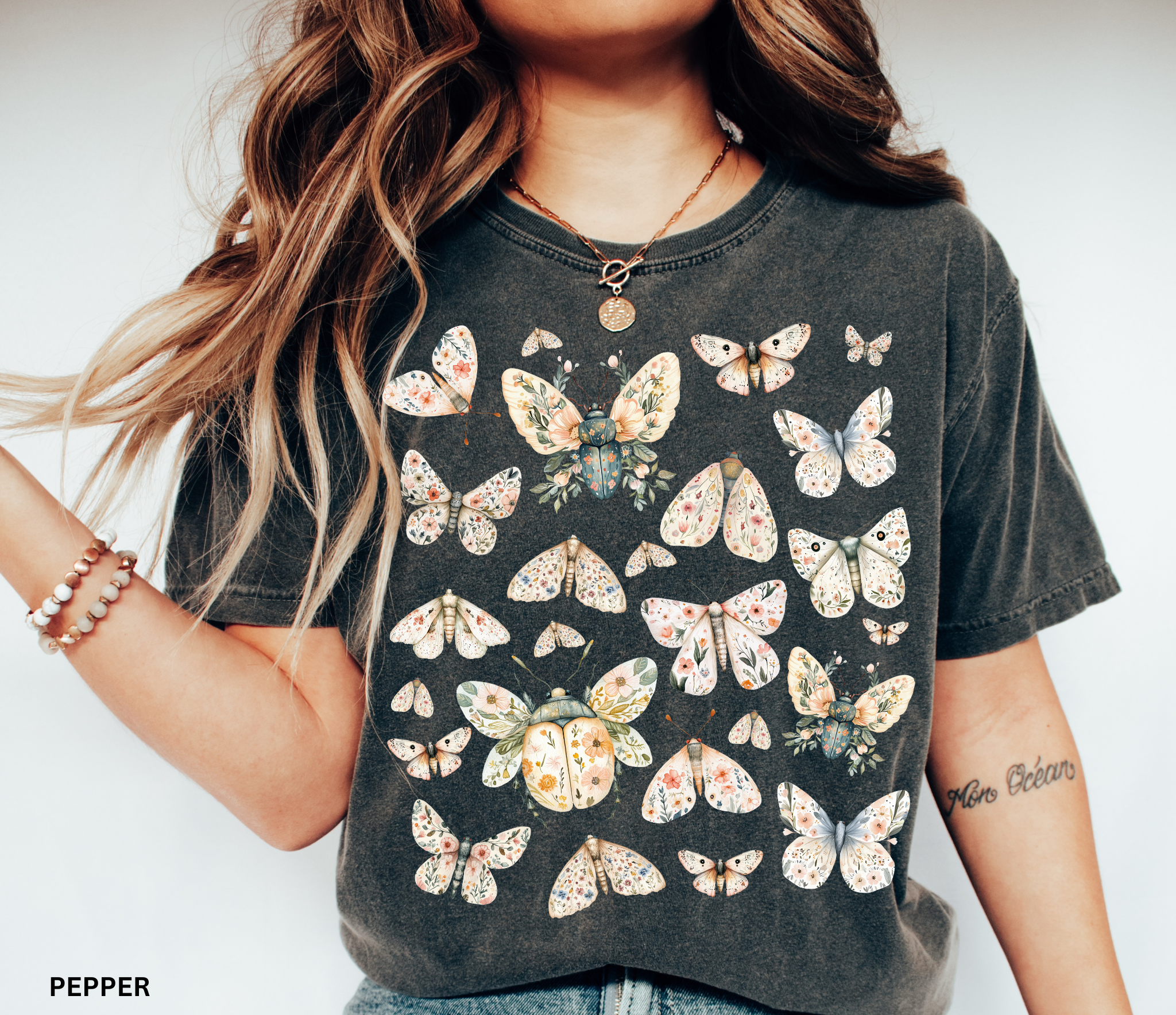 Floral butterfly and moth shirt design featuring pastel wings patterned with flowers, cottagecore nature aesthetic.