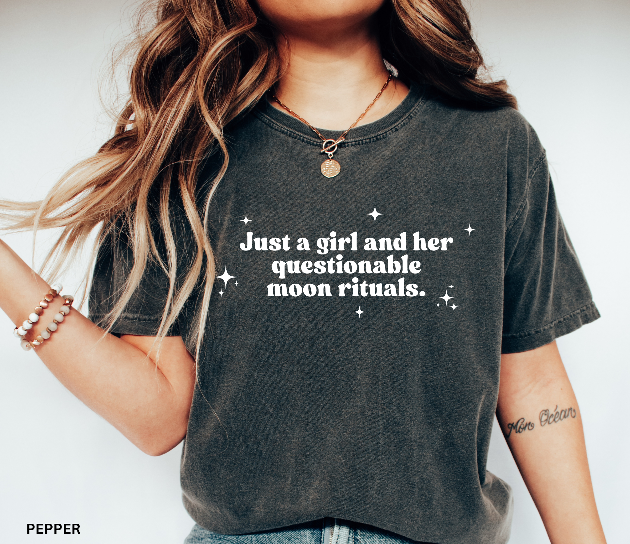 Funny witchy shirt design reading “Just a girl and her questionable moon rituals” with sparkly stars around the text.