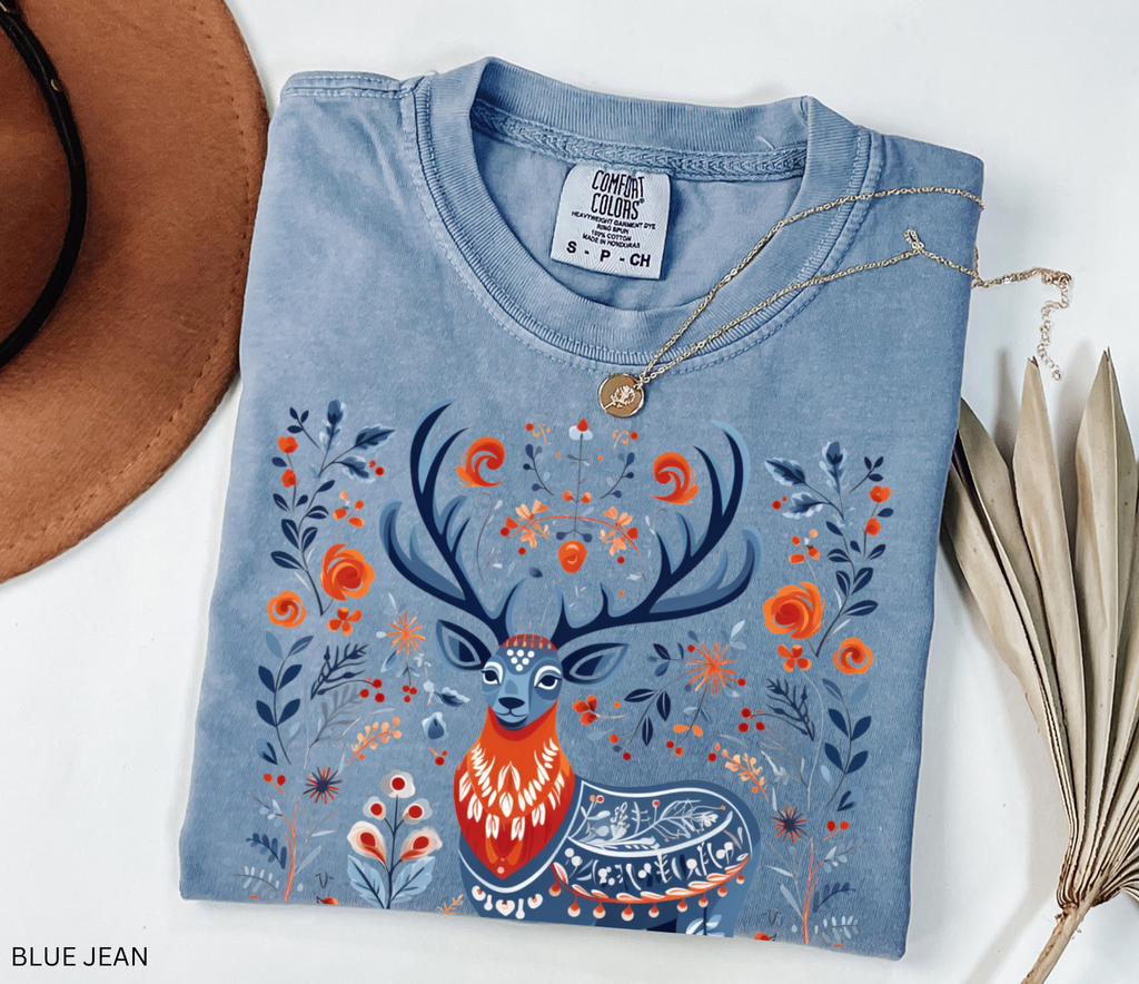 Scandinavian folk art deer shirt design with blue and orange Nordic floral patterns surrounding a majestic stag.