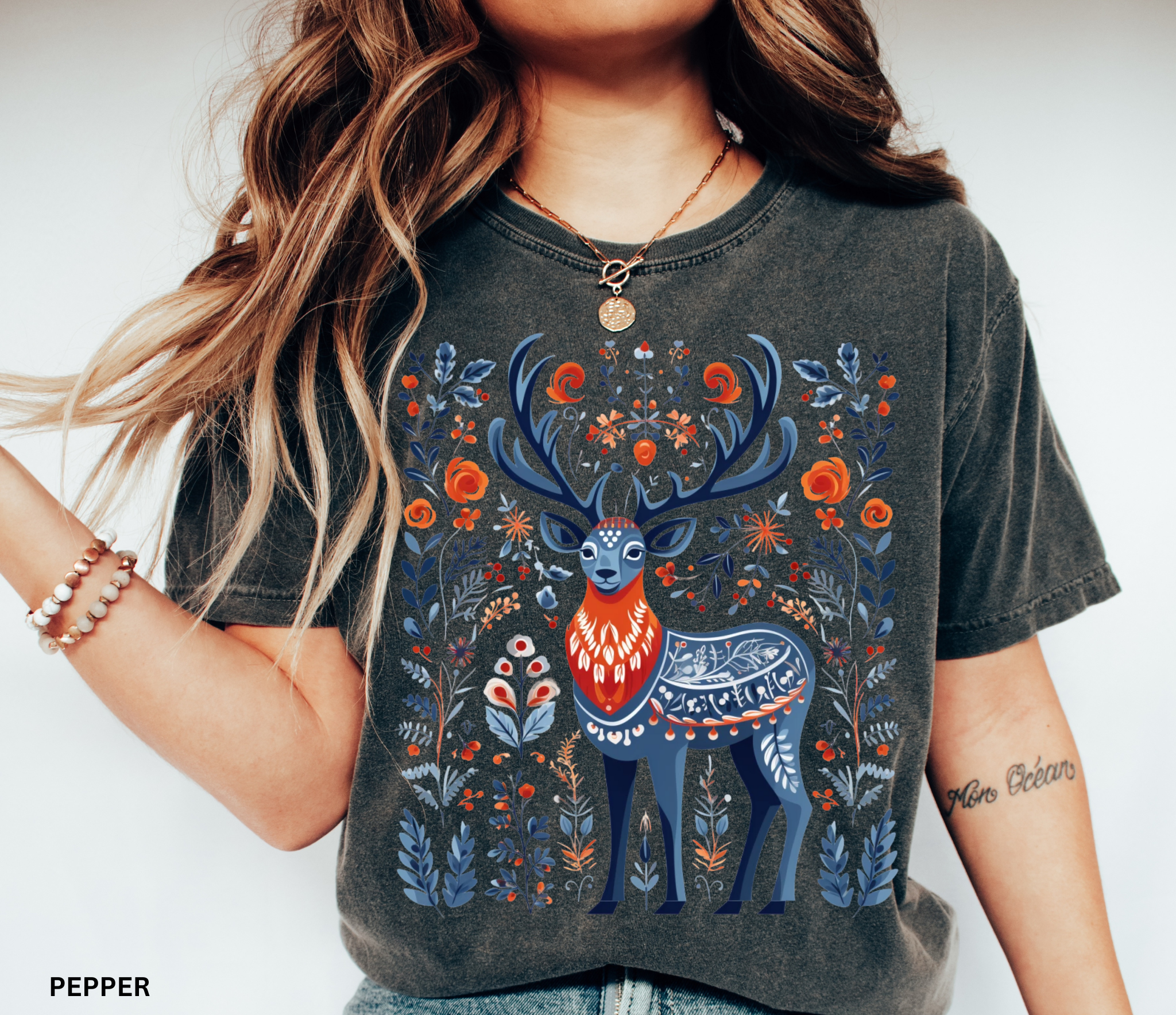 Scandinavian folk art deer shirt design with blue and orange Nordic floral patterns surrounding a majestic stag.