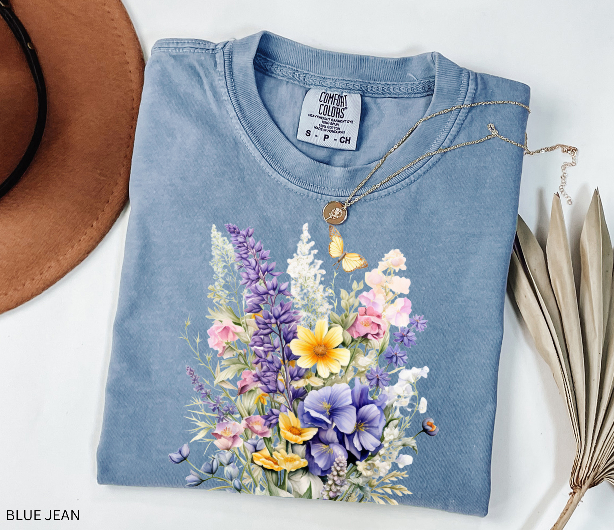 Cottagecore floral shirt design featuring watercolor-style wildflowers and a butterfly, soft botanical vintage aesthetic