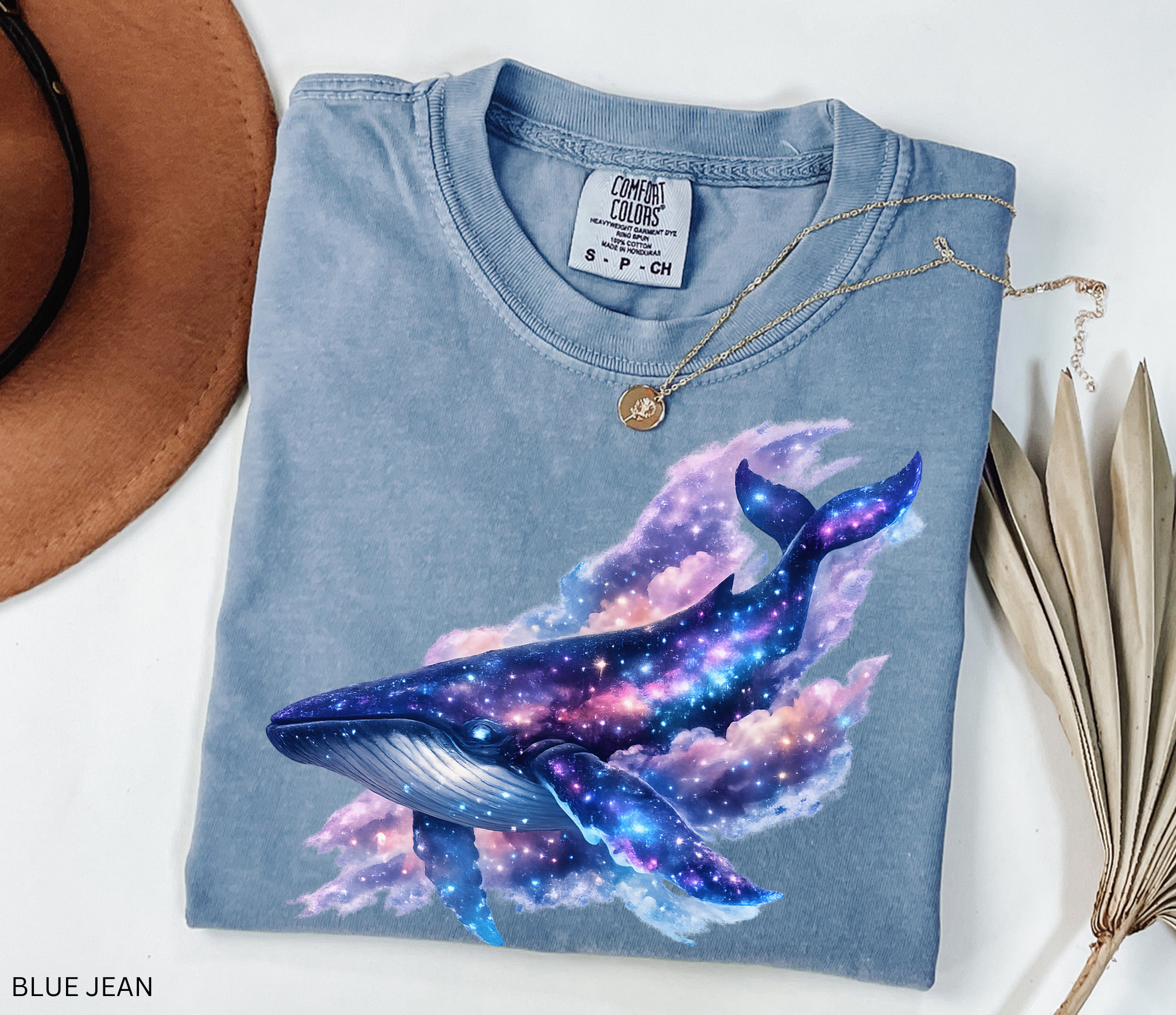 Celestial galaxy whale illustration with stars, nebula clouds, and cosmic colors designed for a whimsical Comfort Colors shirt.
