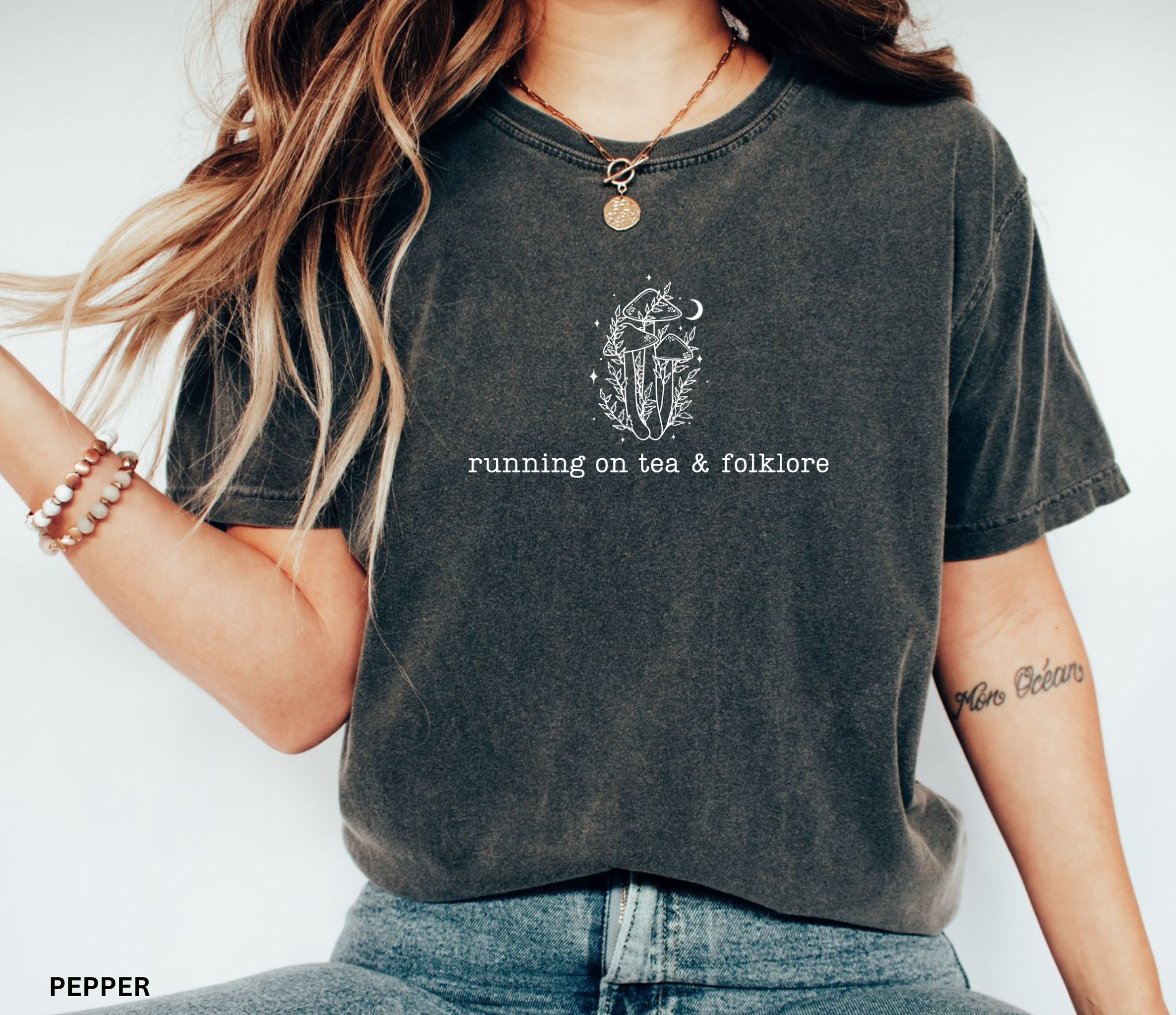 Minimalist whimsical mushroom illustration with moon details and the phrase “running on tea & folklore” in a cottagecore witchy aesthetic design.