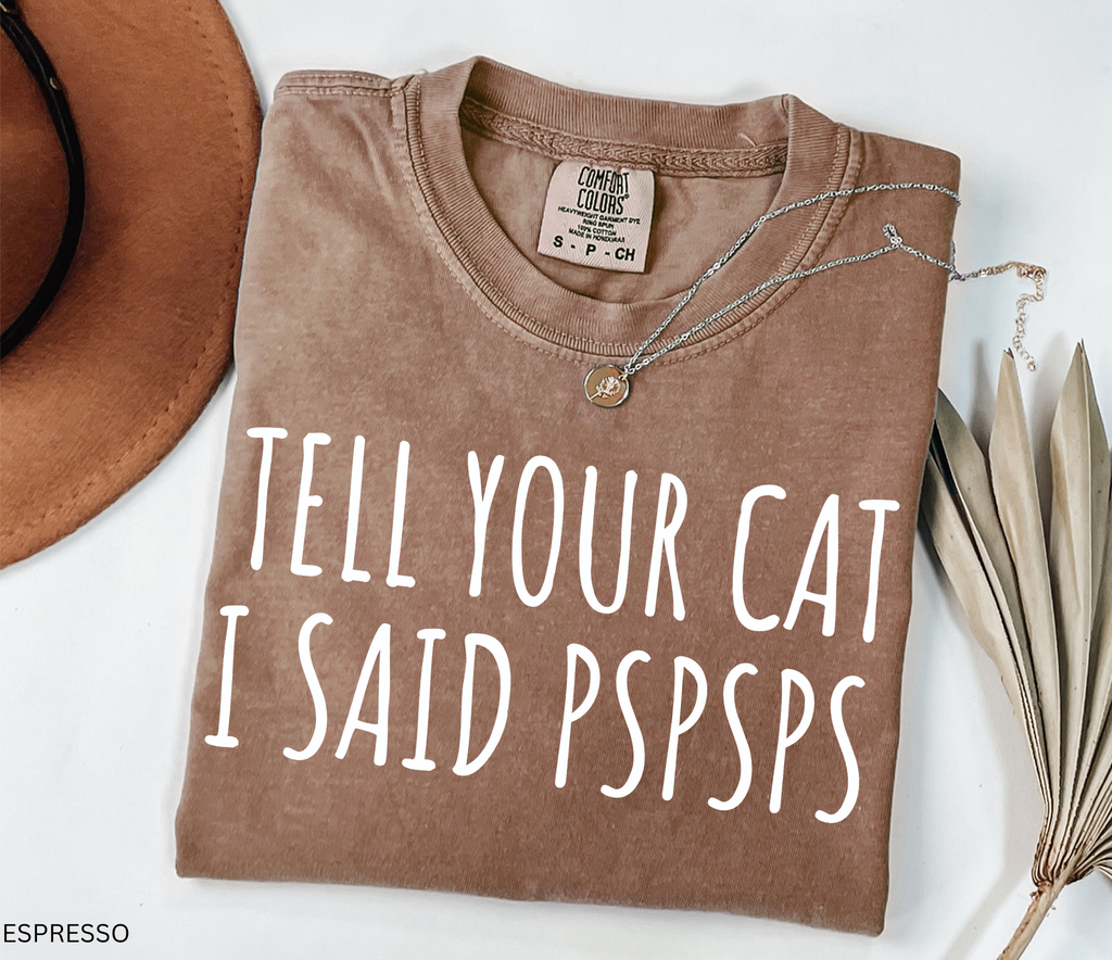 Funny black and white cat lover shirt with the phrase "Tell Your Cat I Said Pspsps," perfect for cat moms, cat dads, pet lovers, and anyone who can't resist greeting every cat they see.
