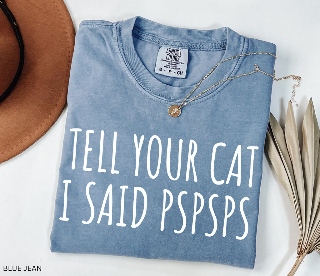 Funny black and white cat lover shirt with the phrase "Tell Your Cat I Said Pspsps," perfect for cat moms, cat dads, pet lovers, and anyone who can't resist greeting every cat they see.