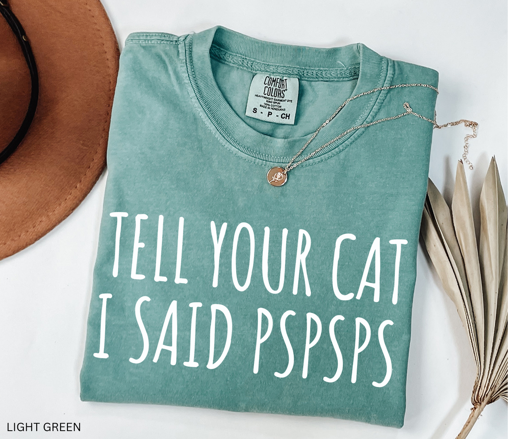 Funny black and white cat lover shirt with the phrase "Tell Your Cat I Said Pspsps," perfect for cat moms, cat dads, pet lovers, and anyone who can't resist greeting every cat they see.