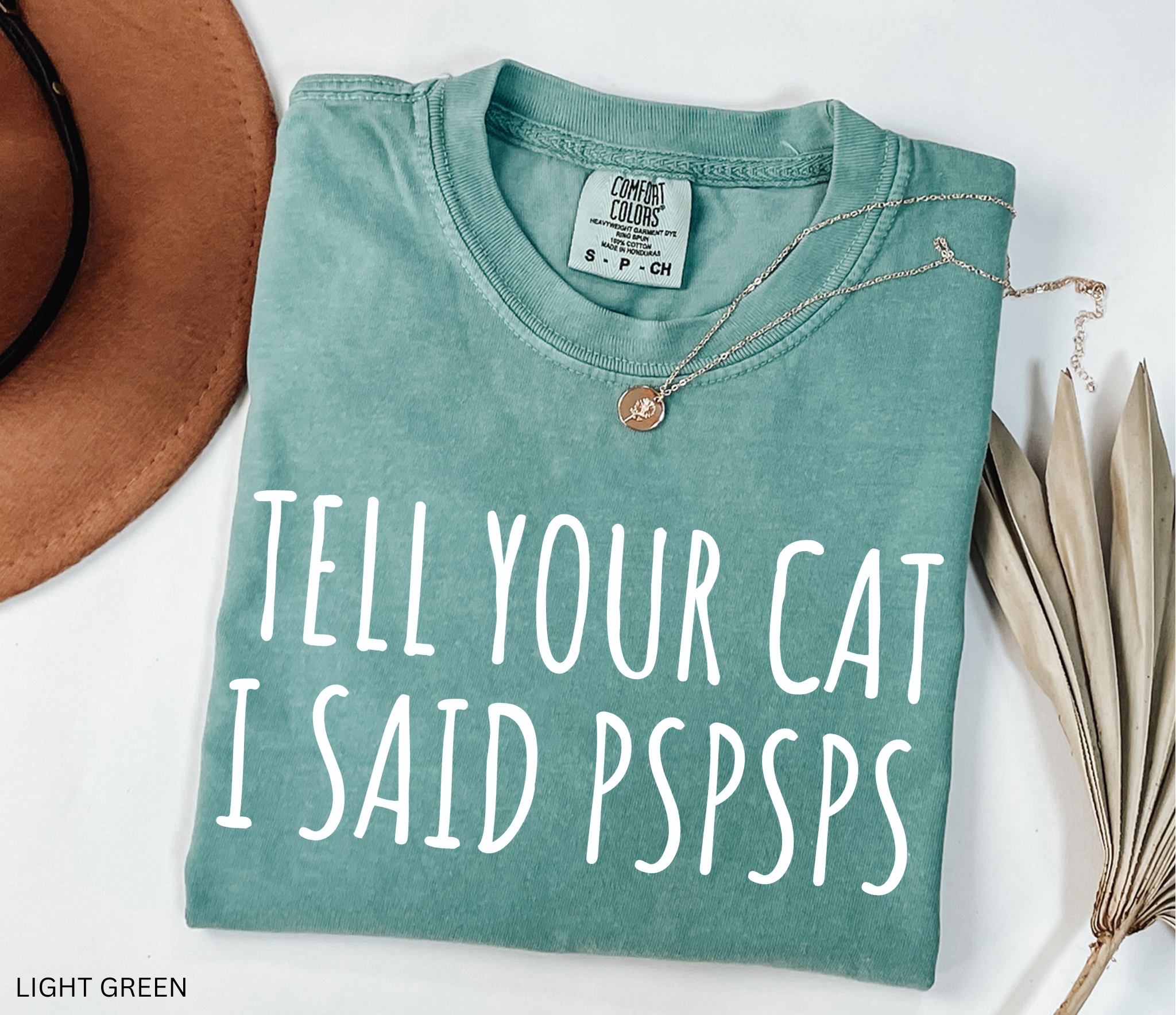 Funny black and white cat lover shirt with the phrase "Tell Your Cat I Said Pspsps," perfect for cat moms, cat dads, pet lovers, and anyone who can't resist greeting every cat they see.