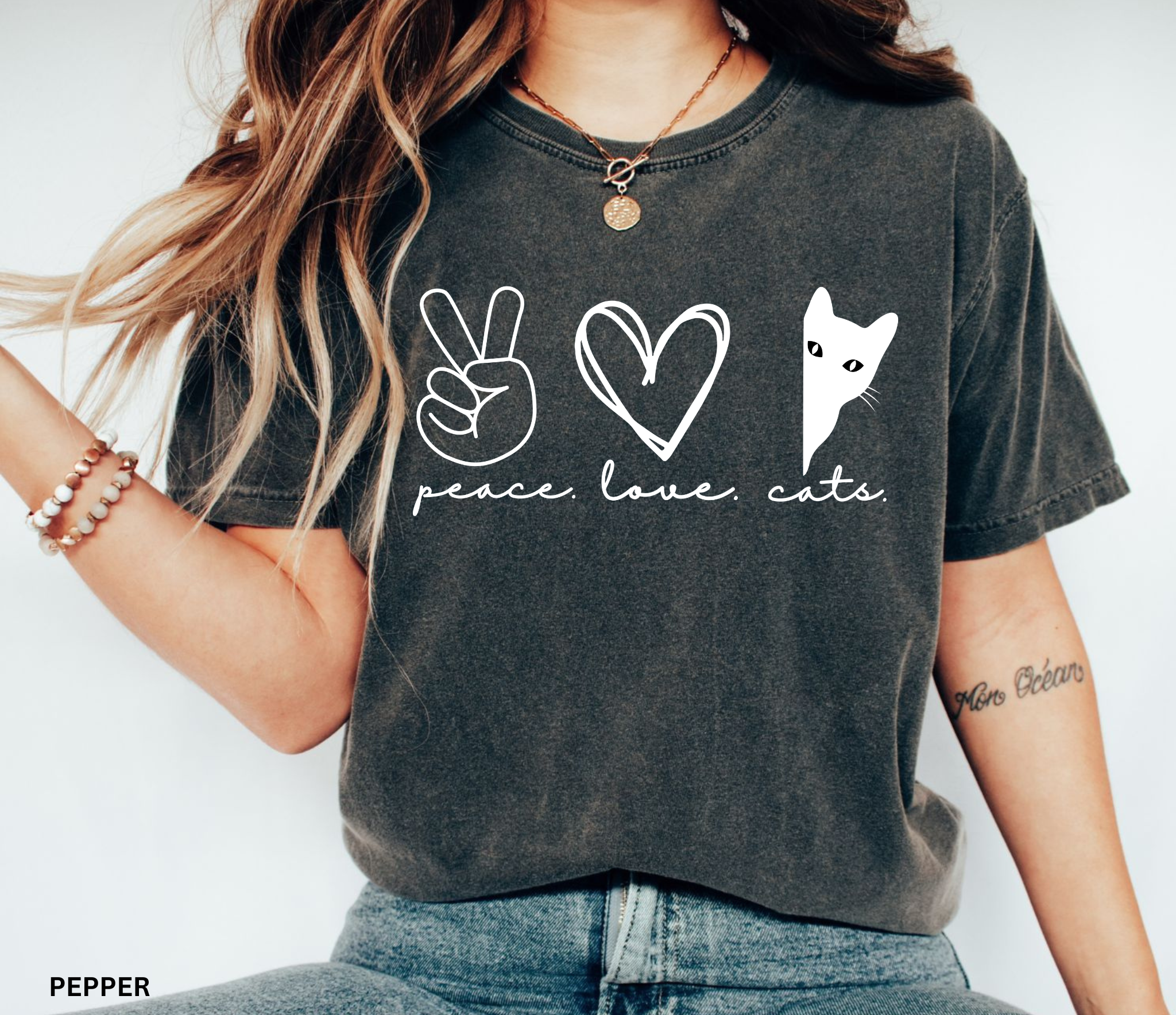 Minimalist peeking black cat graphic printed on a Comfort Colors shirt for cat lovers and black cat owners.