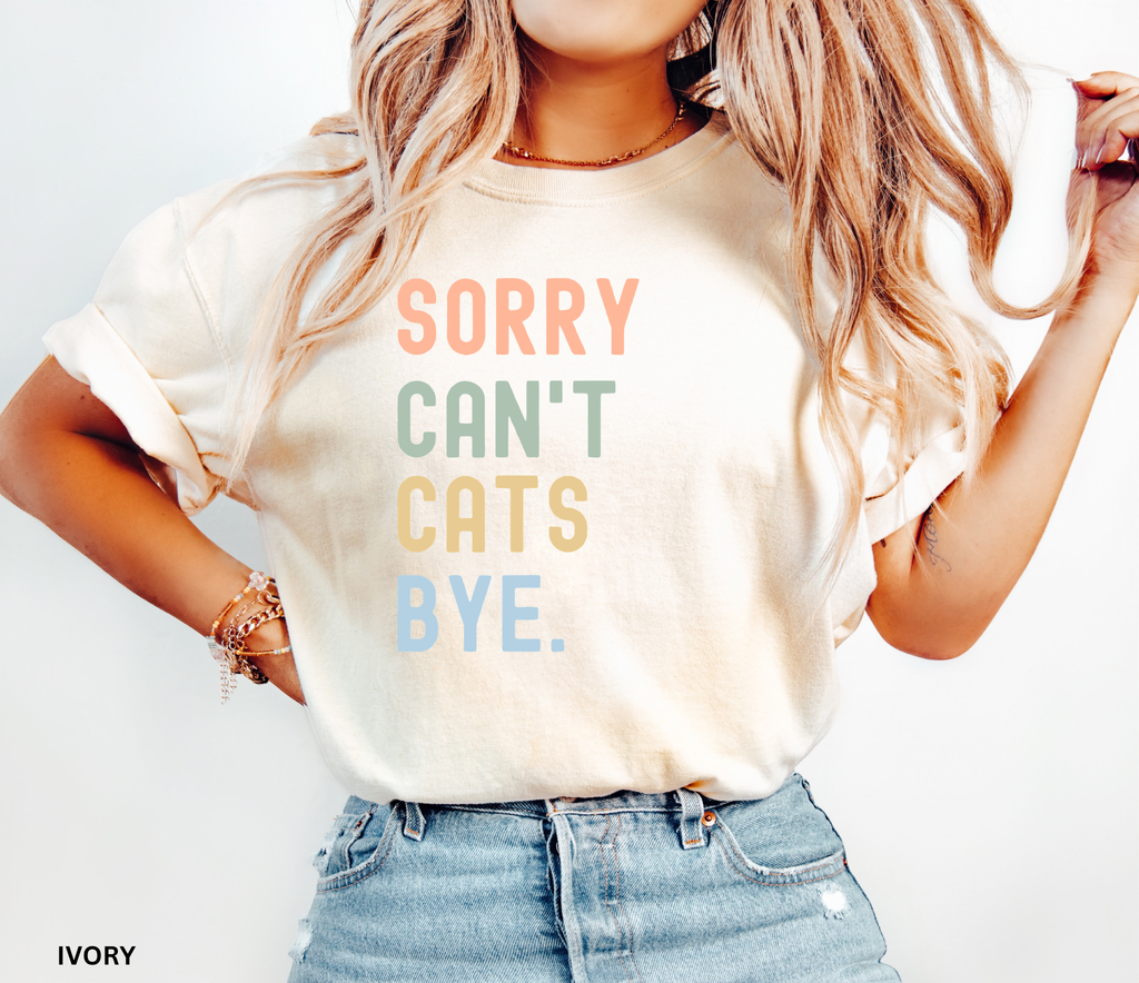 Retro pastel "Sorry Can't Cats Bye" graphic t-shirt featuring colorful vintage lettering for cat lovers, introverts, and proud cat moms.