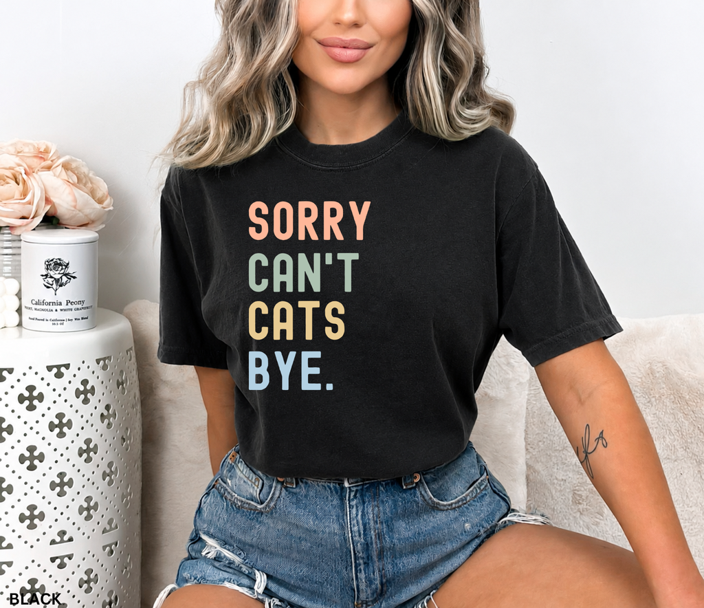 Retro pastel "Sorry Can't Cats Bye" graphic t-shirt featuring colorful vintage lettering for cat lovers, introverts, and proud cat moms.