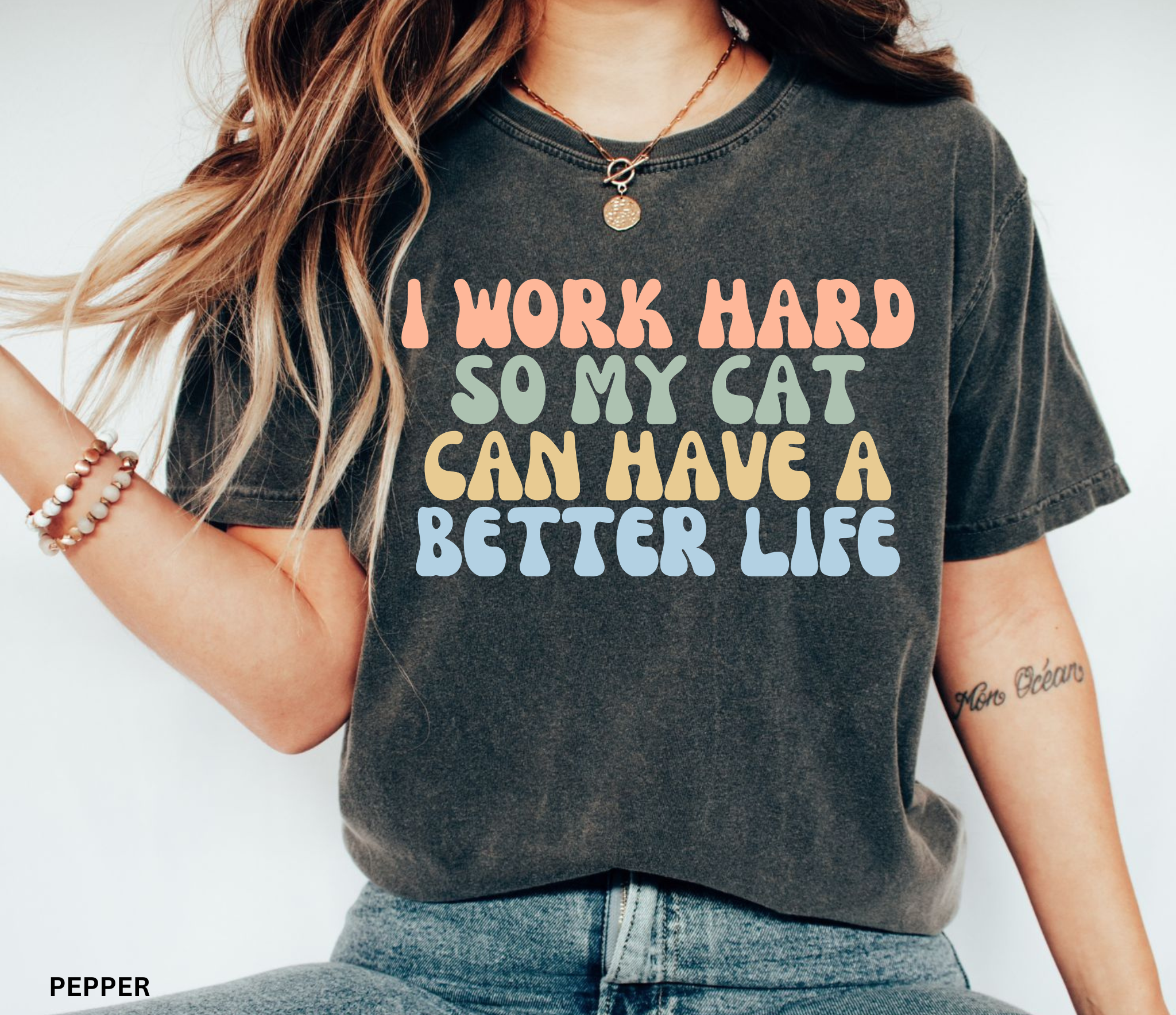 Comfort Colors graphic t-shirt featuring the funny retro quote "I Work Hard So My Cat Can Have A Better Life" in colorful vintage lettering for cat lovers and proud pet parents.