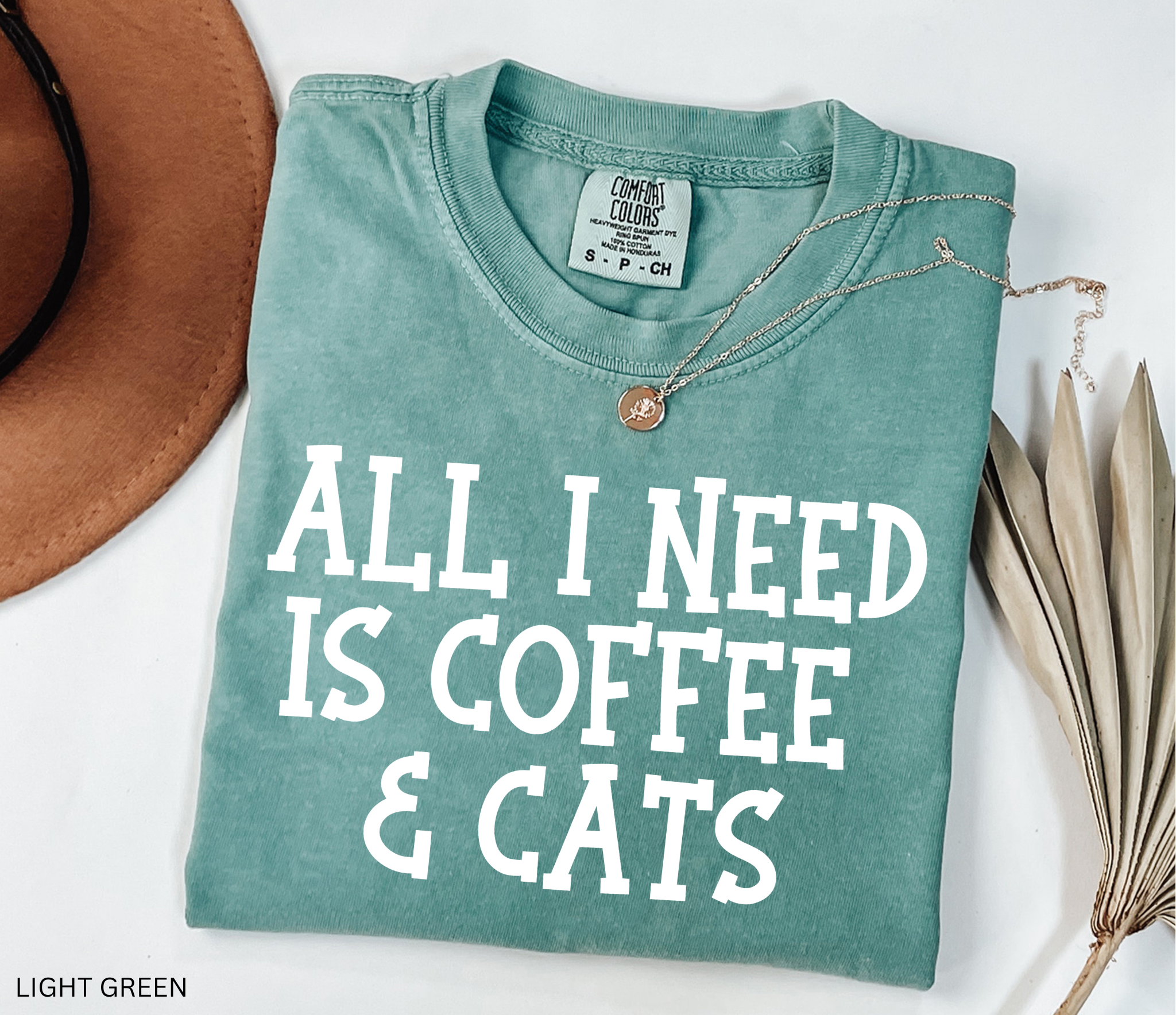 Comfort Colors graphic t-shirt featuring the phrase "All I Need Is Coffee & Cats" in bold vintage lettering, perfect for coffee lovers, cat moms, and animal lovers.