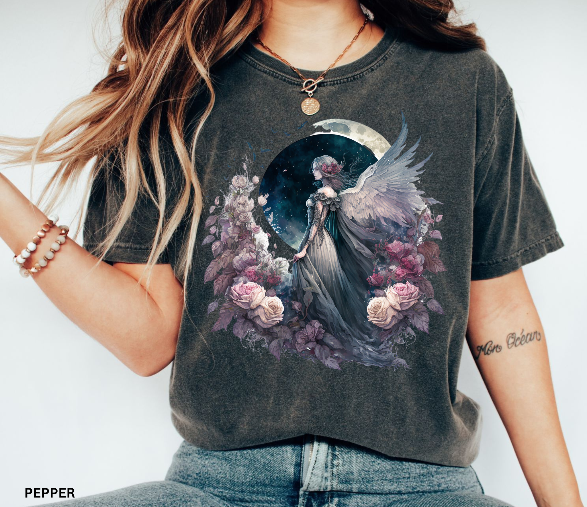 Celestial Angel Moon Graphic Tee on Comfort Colors pepper t-shirt featuring a winged angel beneath a full moon with blooming roses, perfect for fairycore, cottagecore, celestial, and witchy fashion.