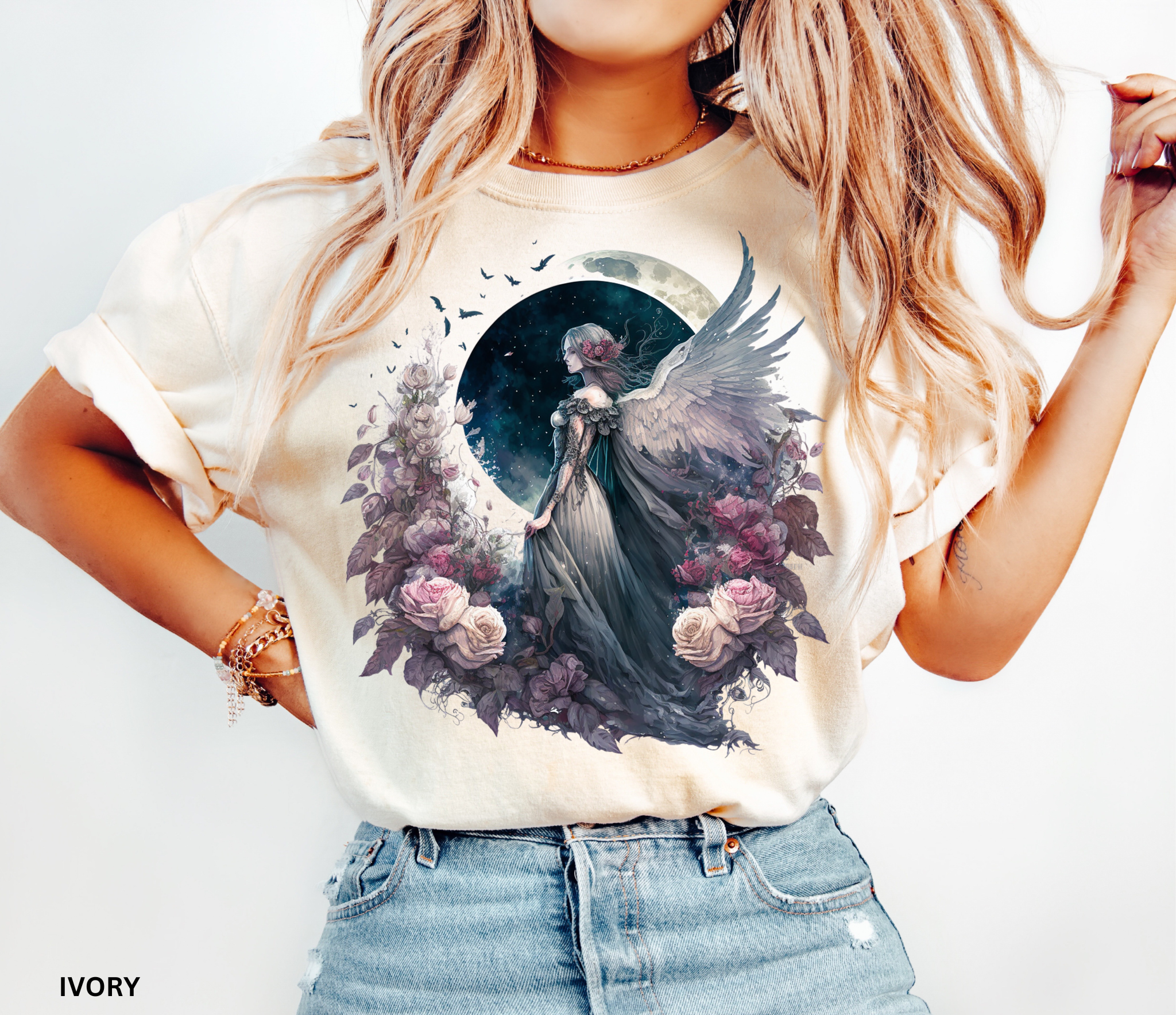 Celestial Angel Moon Graphic Tee on Comfort Colors ivory t-shirt featuring a winged angel beneath a full moon with blooming roses, perfect for fairycore, cottagecore, celestial, and witchy fashion.