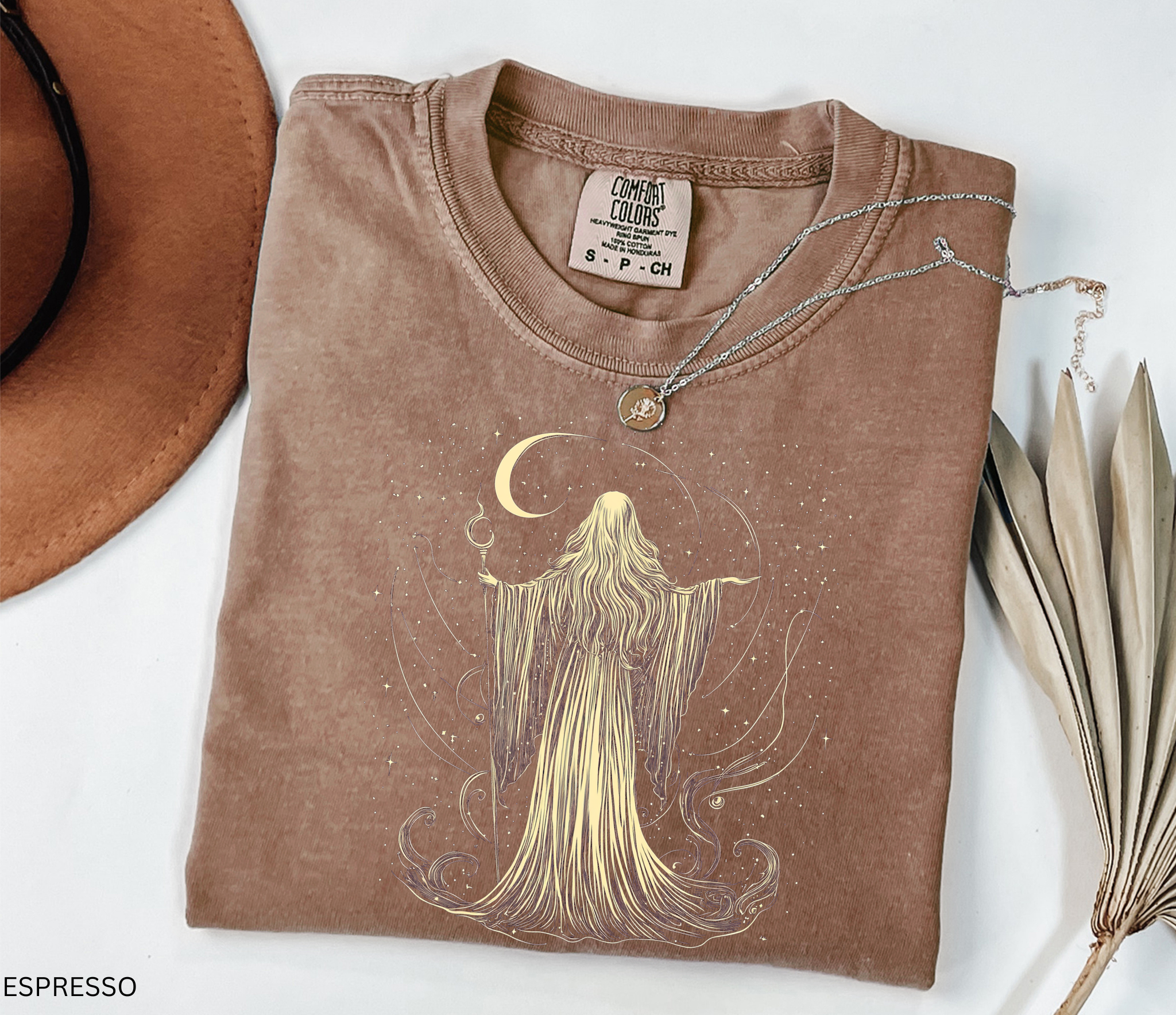 Vintage Comfort Colors t-shirt featuring an elegant moon priestess standing beneath a crescent moon surrounded by stars and flowing celestial magic. Available in Blue Jean, Espresso, Pepper, and Black.