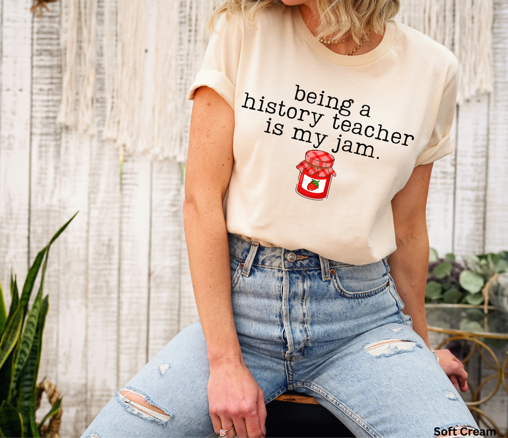 Shop the “Being a History Teacher Is My Jam” shirt featuring a cute strawberry jam design. A funny history teacher tee for school outfits, teacher gifts and back to school.