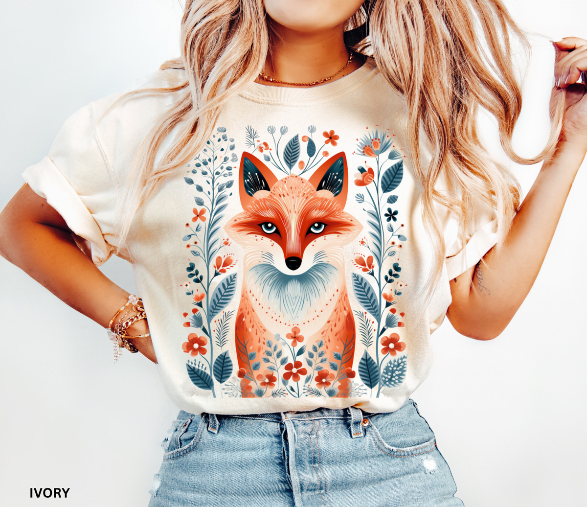 Nordic folk art fox graphic t-shirt featuring orange and blue floral botanical details.