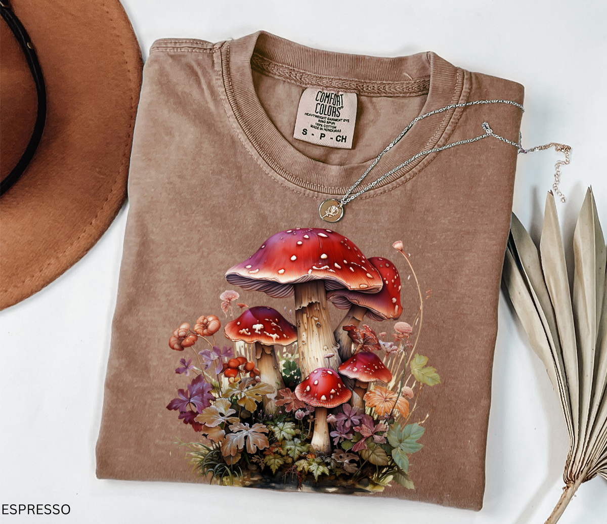 Red mushroom graphic t-shirt featuring a detailed cluster of woodland toadstools surrounded by autumn foliage and botanical details.