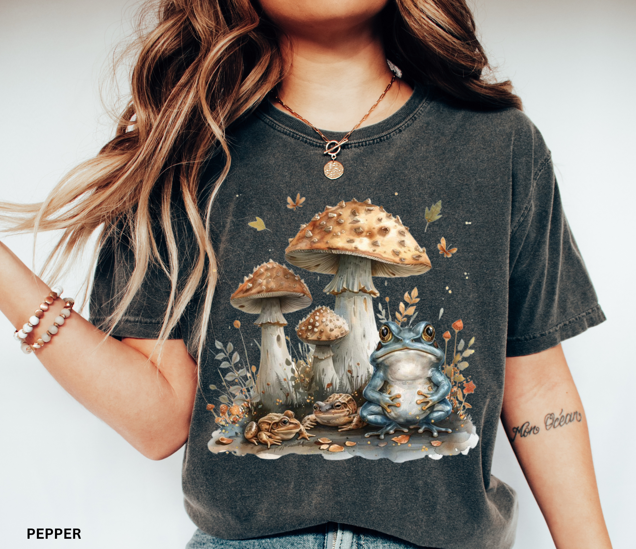 Illustrated frogs sitting beneath tall woodland mushrooms with leaves and forest details in a whimsical cottagecore style on a black background.