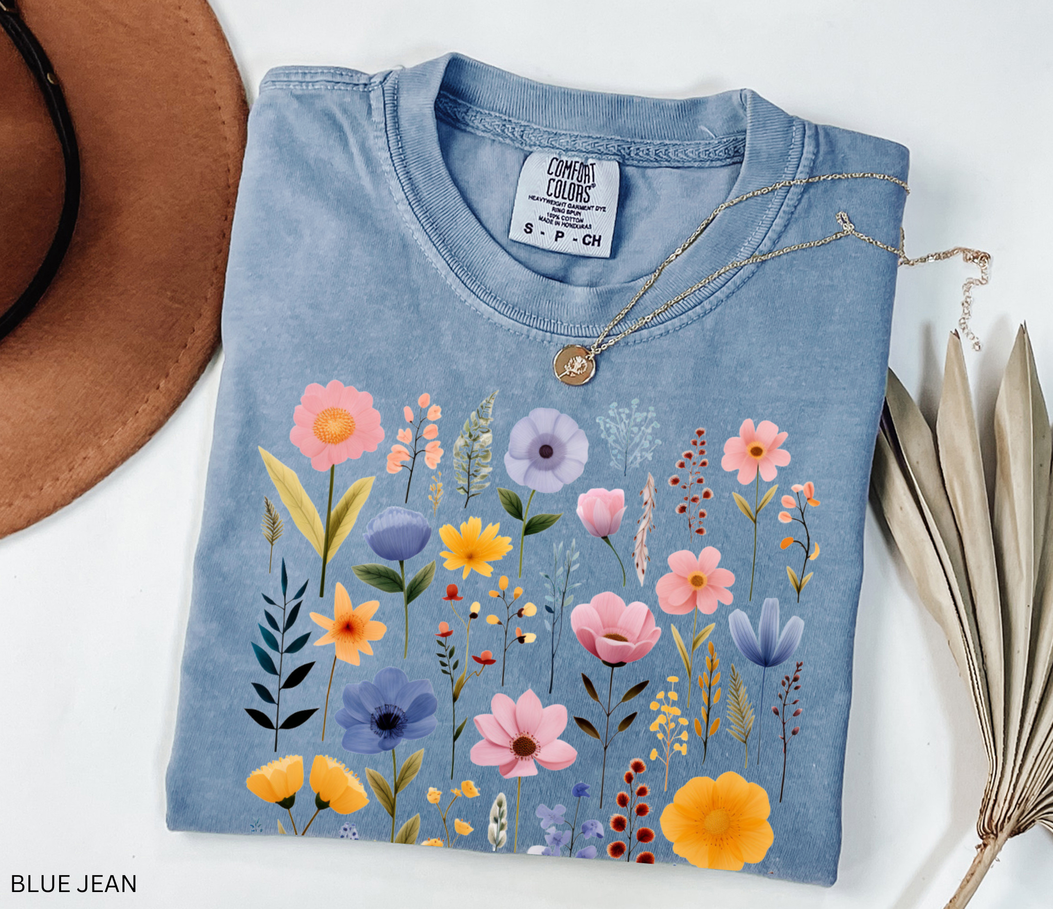 Comfort Colors shirt featuring a pastel Nordic wildflower botanical design with soft pink, blue, and yellow florals in a cottagecore style