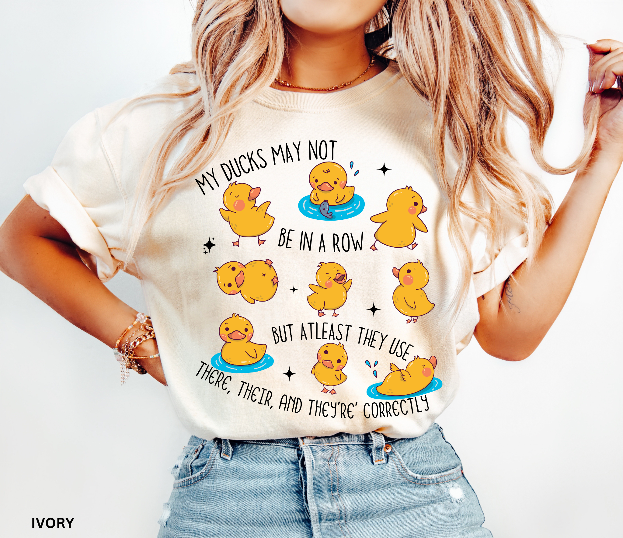Playful duck illustration with the phrase ‘My ducks may not be in a row, but at least they use there, their, and they’re correctly,’ designed as a humorous shirt for English teachers.