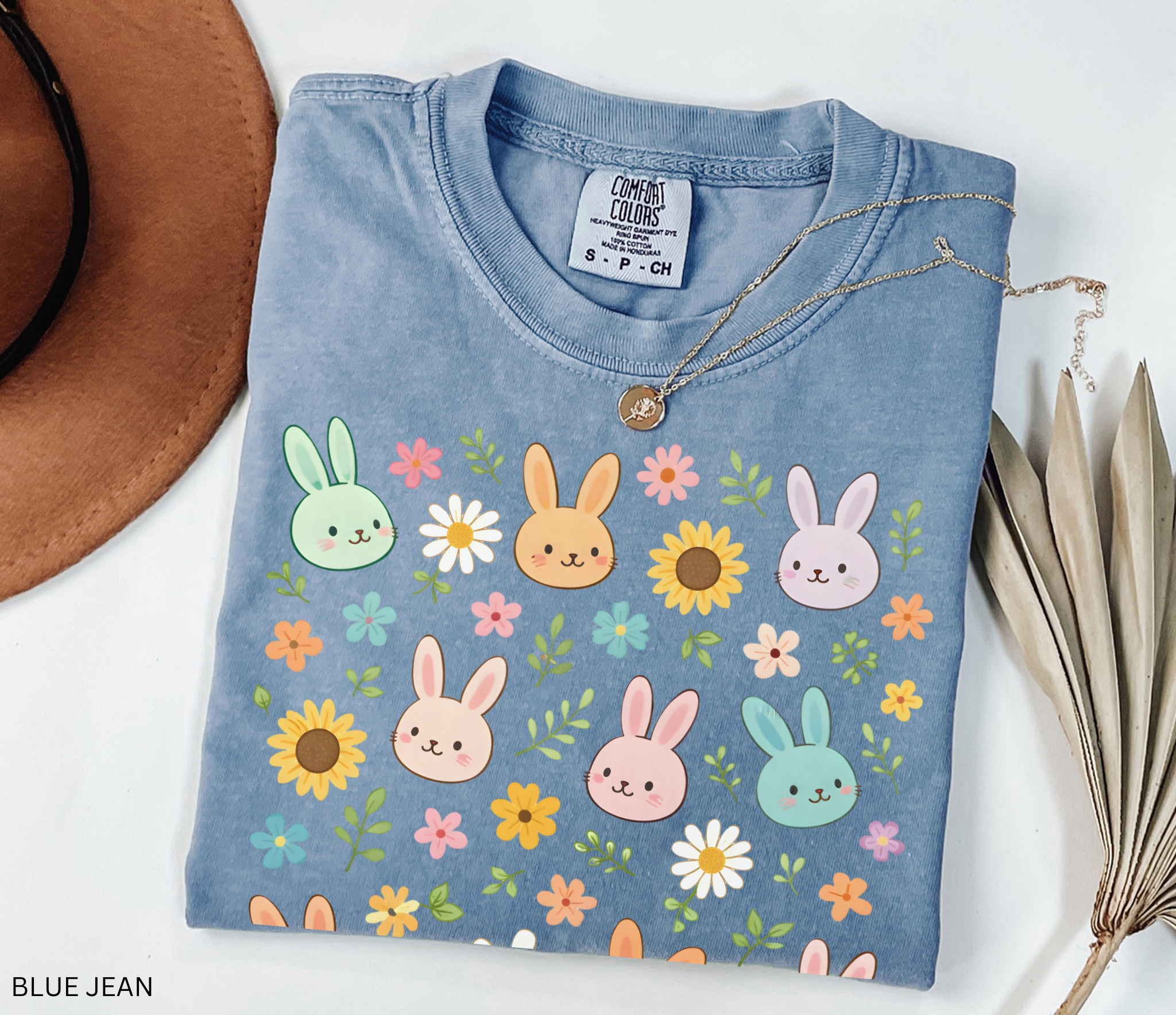 Floral cottagecore bunny shirt with pastel rabbits and wildflowers on a dark background, whimsical woodland aesthetic