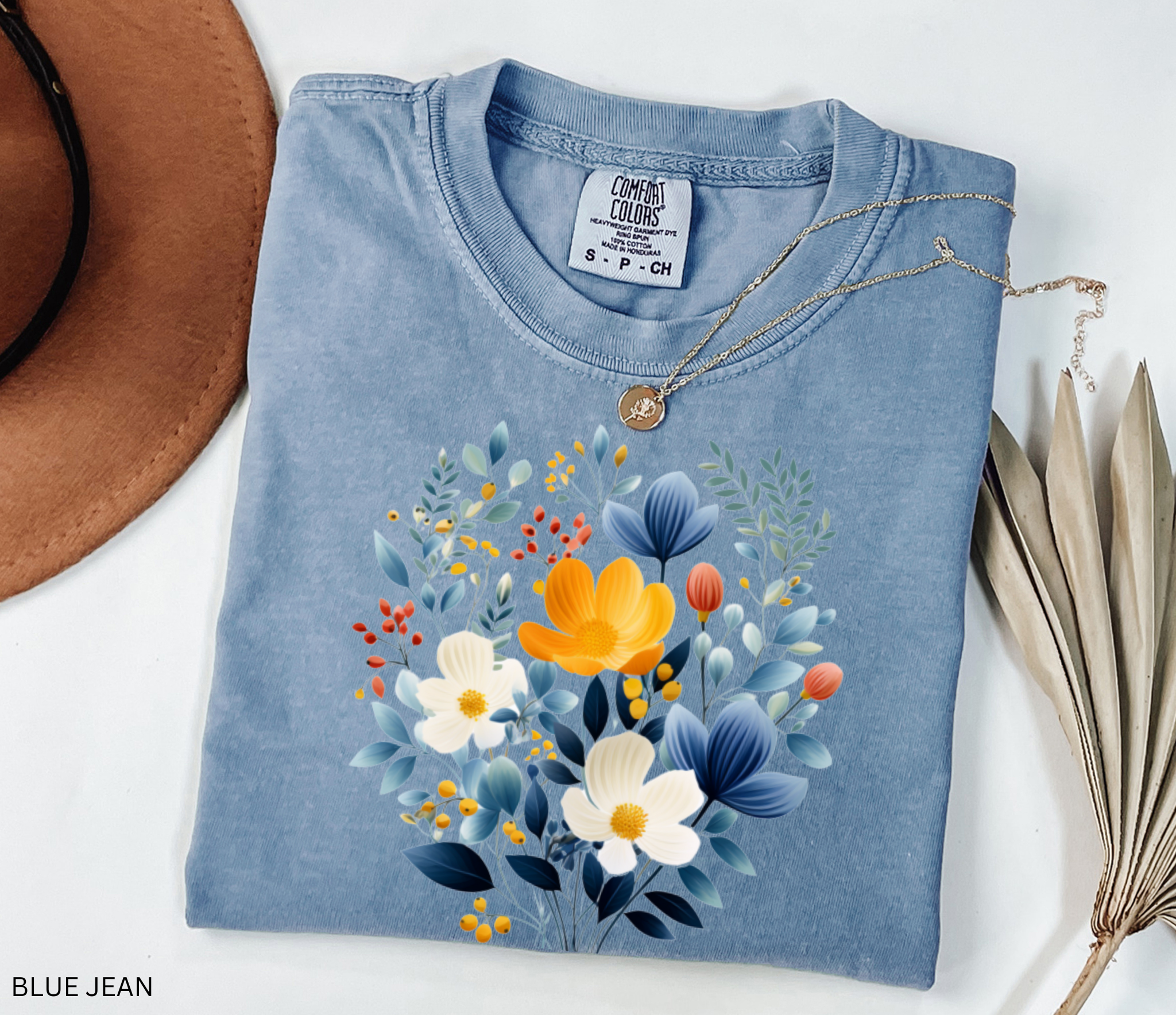 Nordic folk wildflower bouquet with blue, ivory, and yellow flowers on a cottagecore floral shirt