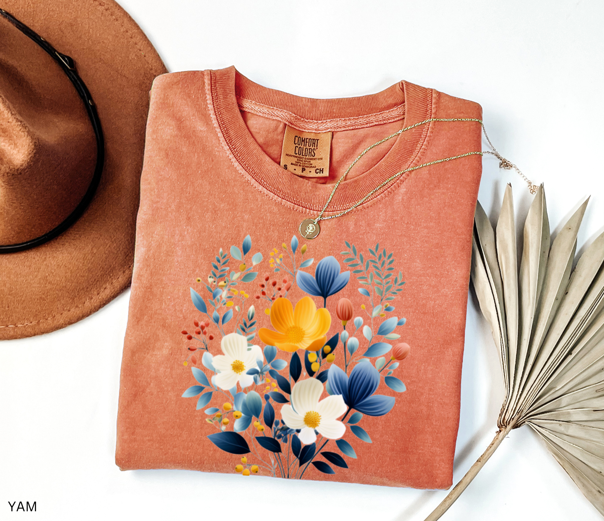 Nordic folk wildflower bouquet with blue, ivory, and yellow flowers on a cottagecore floral shirt